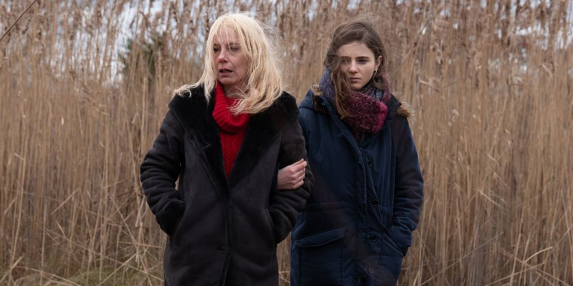 Amy Ryan and Oona Laurence standing in a field arm in arm in Lost Girls