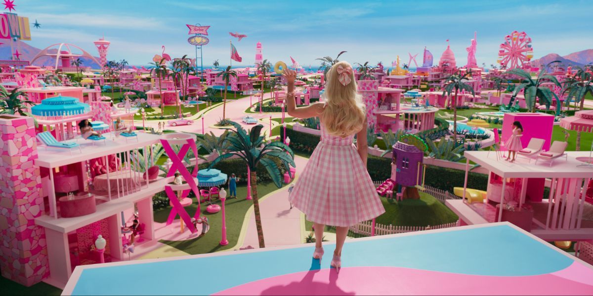 Margot Robbie as Barbie looking out at Barbieland