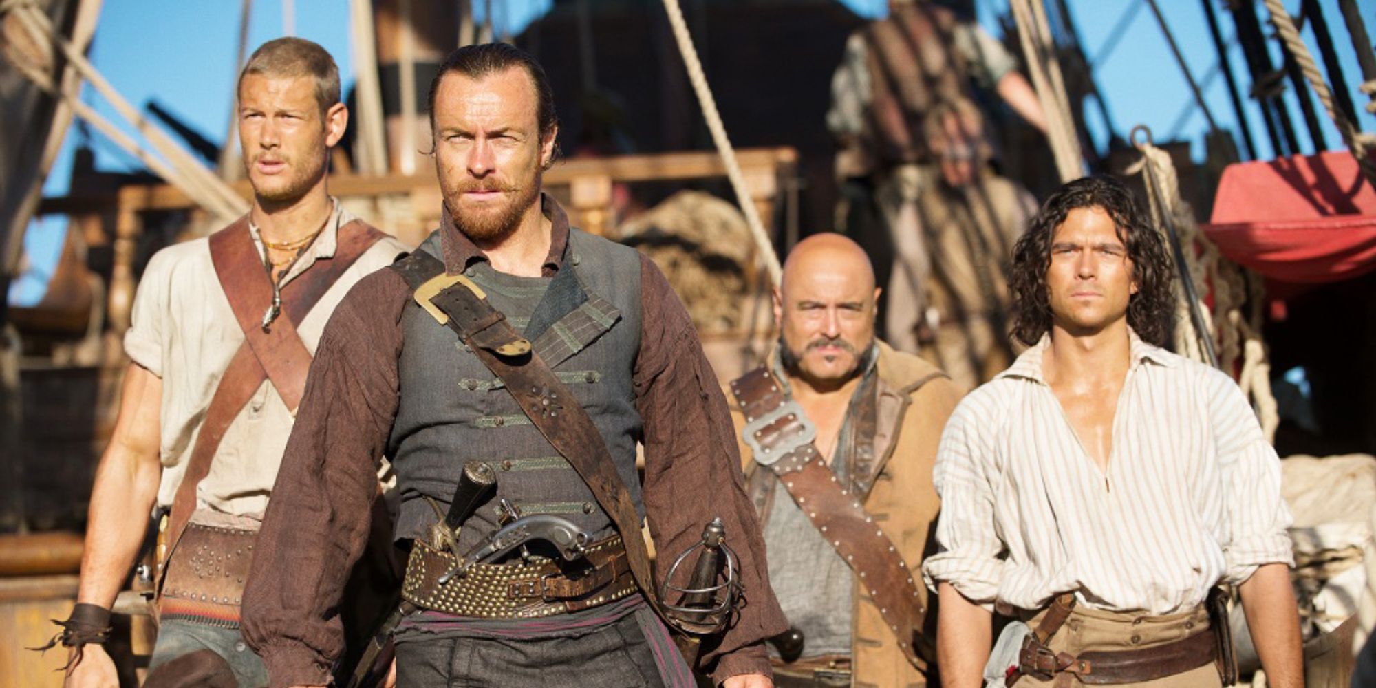 Captain Flint and John Silver standing on a ship's deck in Black Sails.