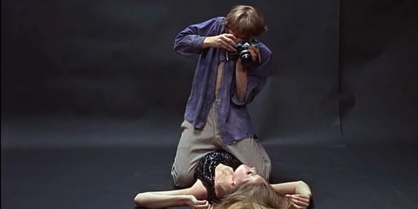 David Hemmings as Thomas, a photographer, kneeling over model Veruschka von Lehndorff and taking her picture from above in Blow-Up