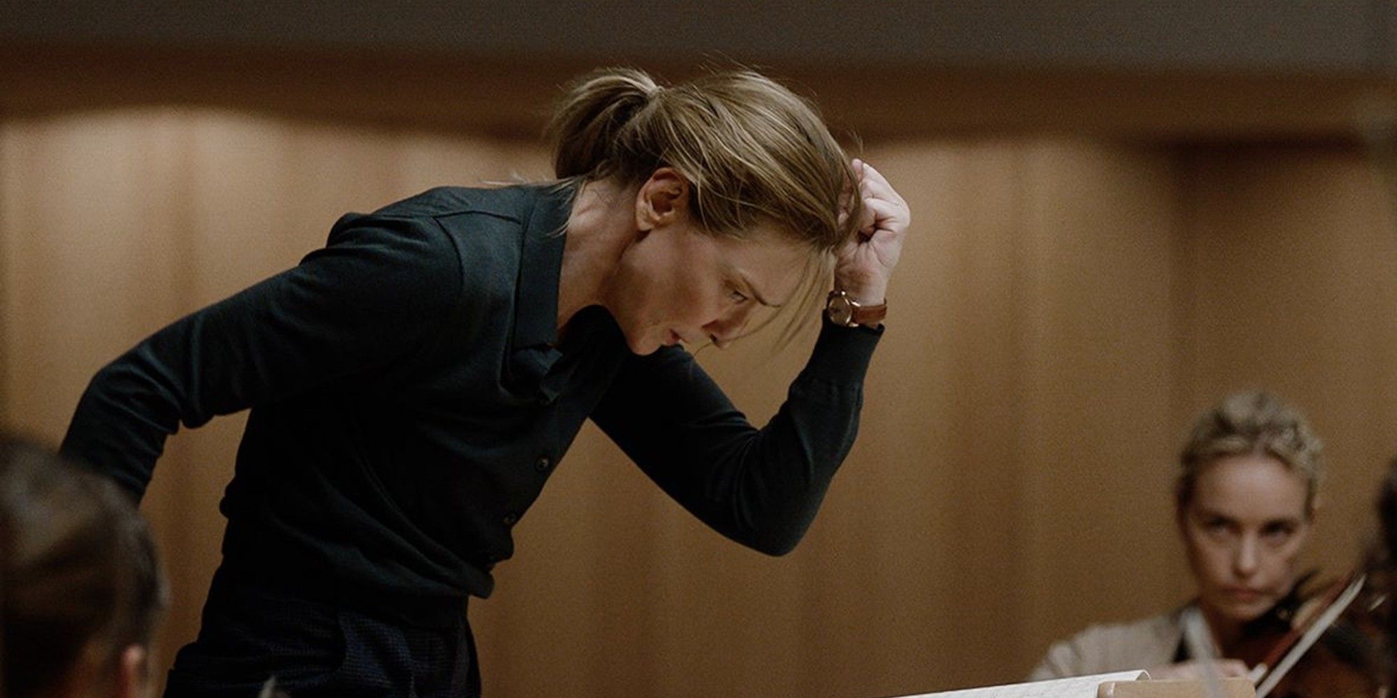 Lydia Tár (Cate Blanchett) impassioned as she conducts her orchestra in 'Tár'.