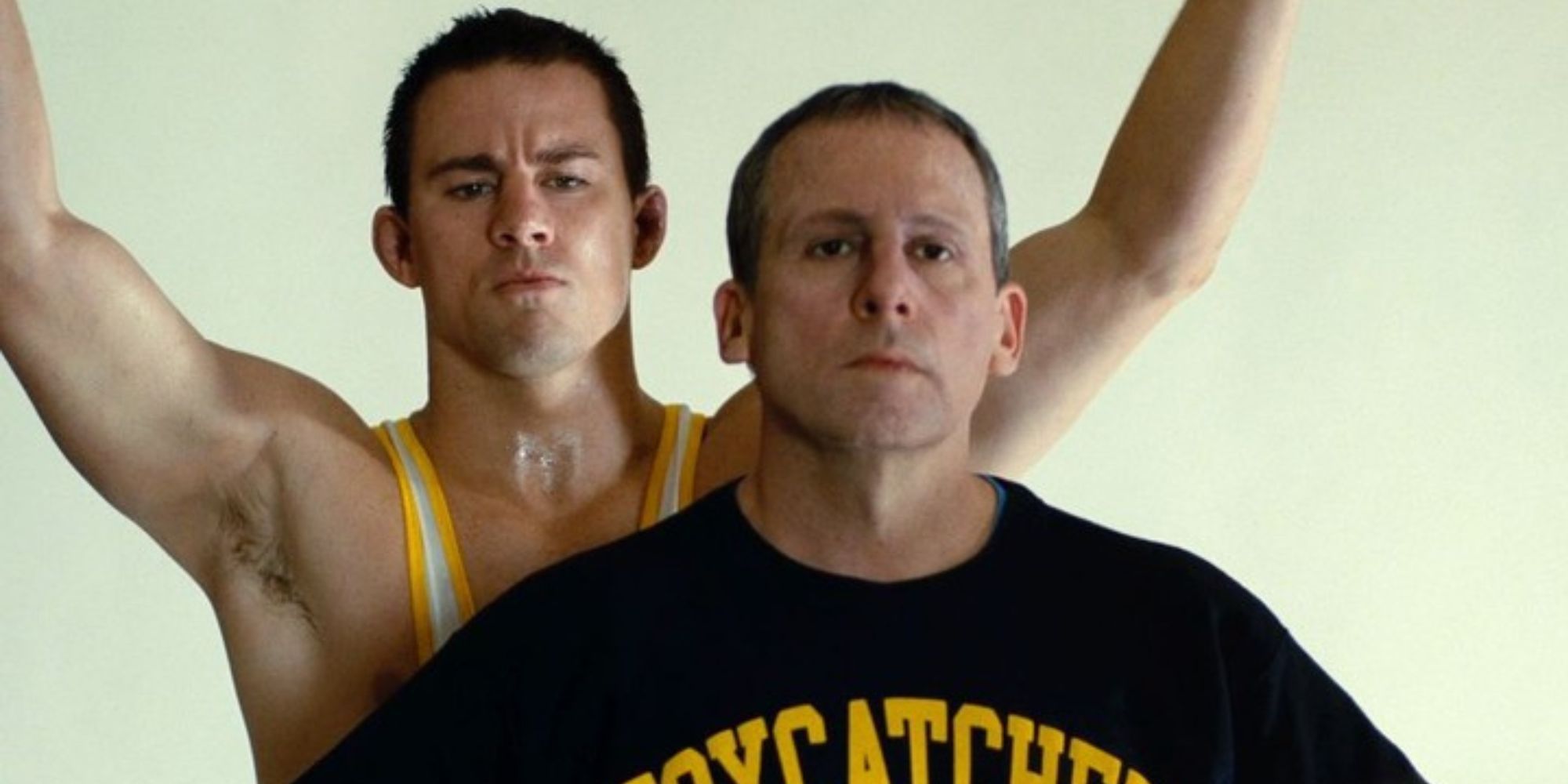 Channing Tatum stands behind Steve Carell in Foxcatcher