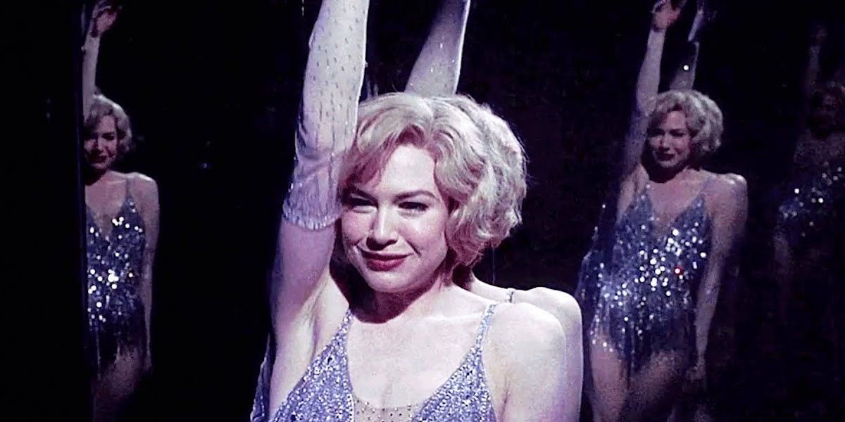 Roxie Hart smiling while leaning against a mirror in Chicago.