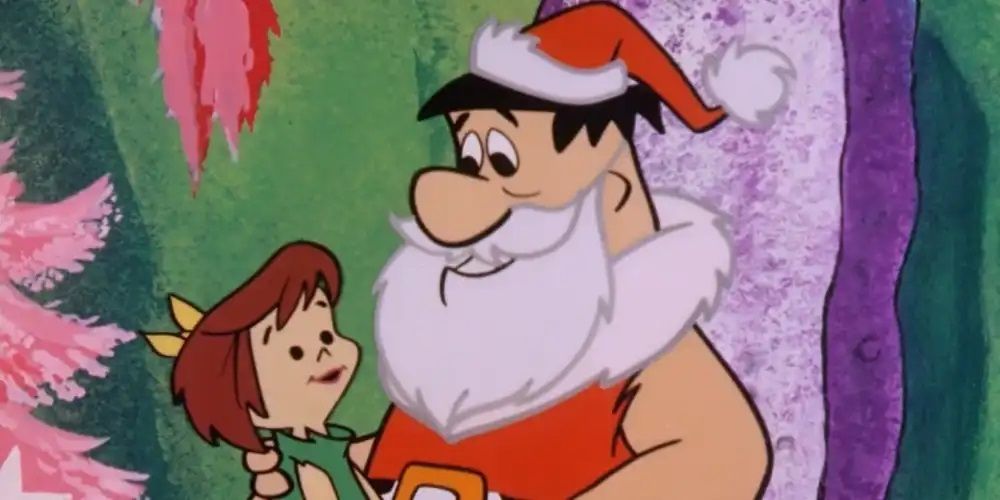 Fred Flintstone dressed as Santa Claus with a child