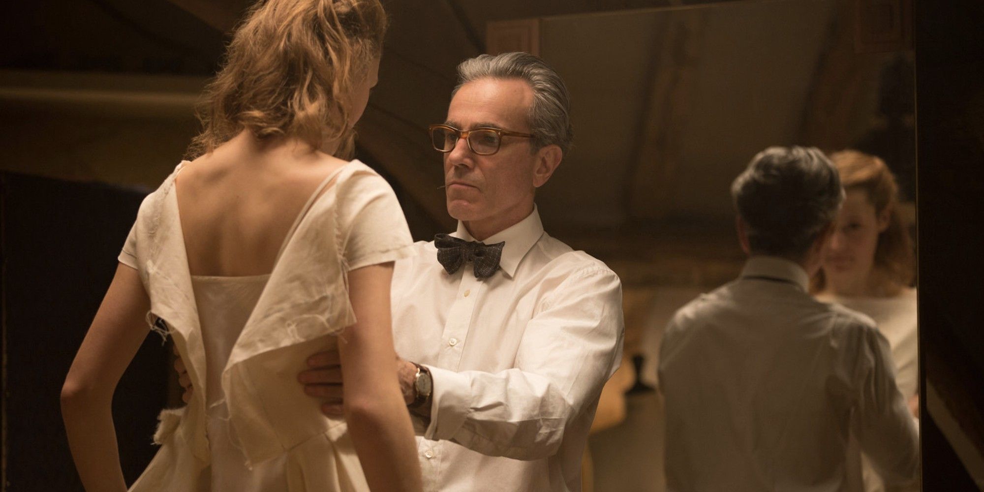 Daniel-Day Lewis fixing Vicky Krieps' dress in 'Phantom Thread'