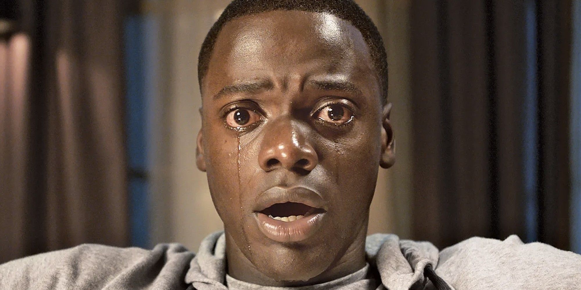 Daniel Kaluuya looks frightened, sheds tears and stands open-mouthed in shock in “Get Out.”