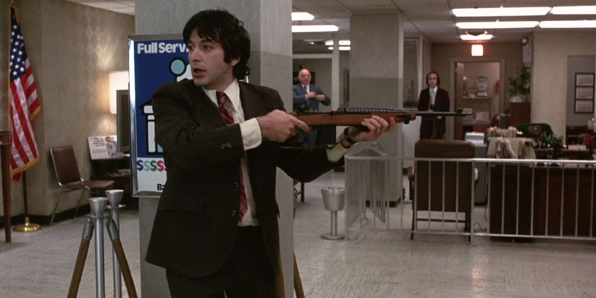 Al Pacino as Sonny aiming a gun while at a bank in Dog Day Afternoon