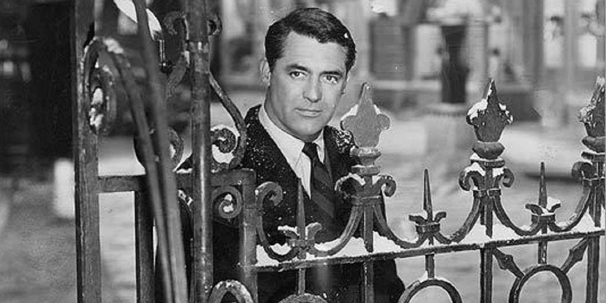Cary Grant as Dudley looking over a fence to the distance in The Bishop's Wife