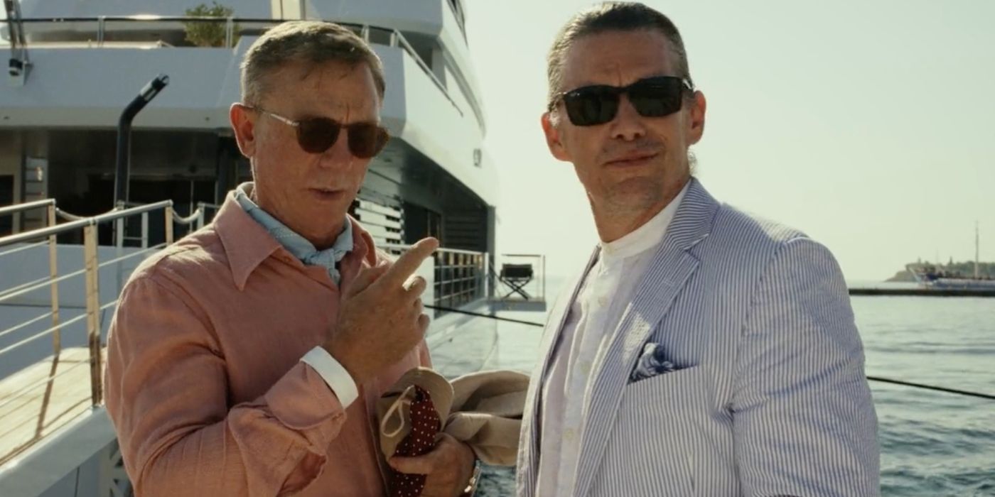 Daniel Craig as Benoit Blanc and the Ethan Hawke as Efficient Man at a dock in Glass Onion