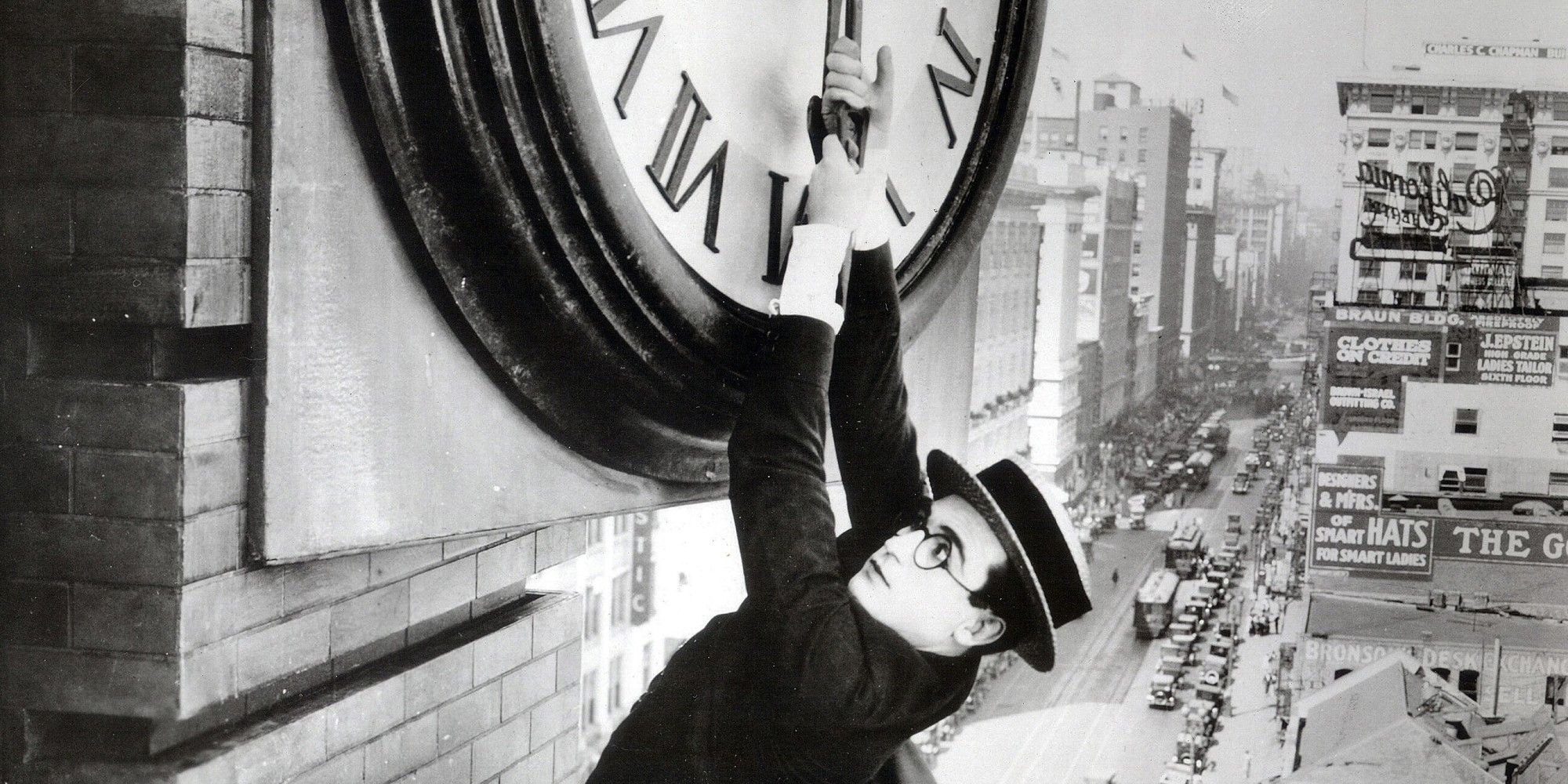 Harold Lloyd holding from a clock hand in 'Safety Last!'