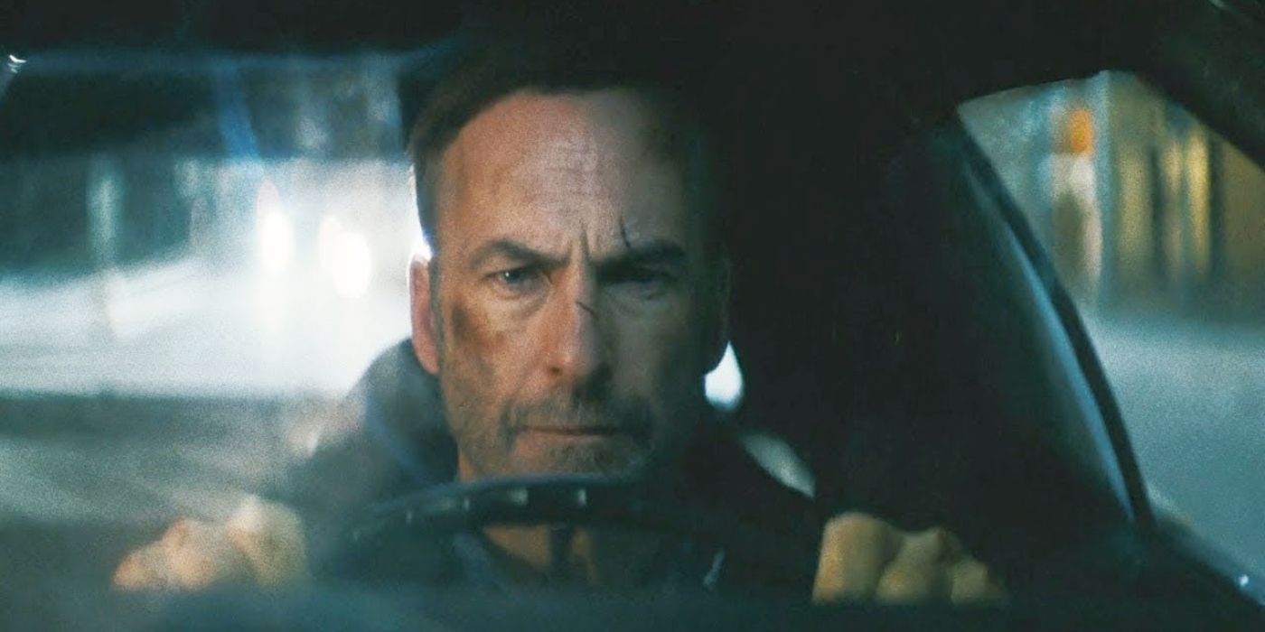 Hutch (Bob Odenkirk), with bruises and cuts on his face, drives his car in Nobody