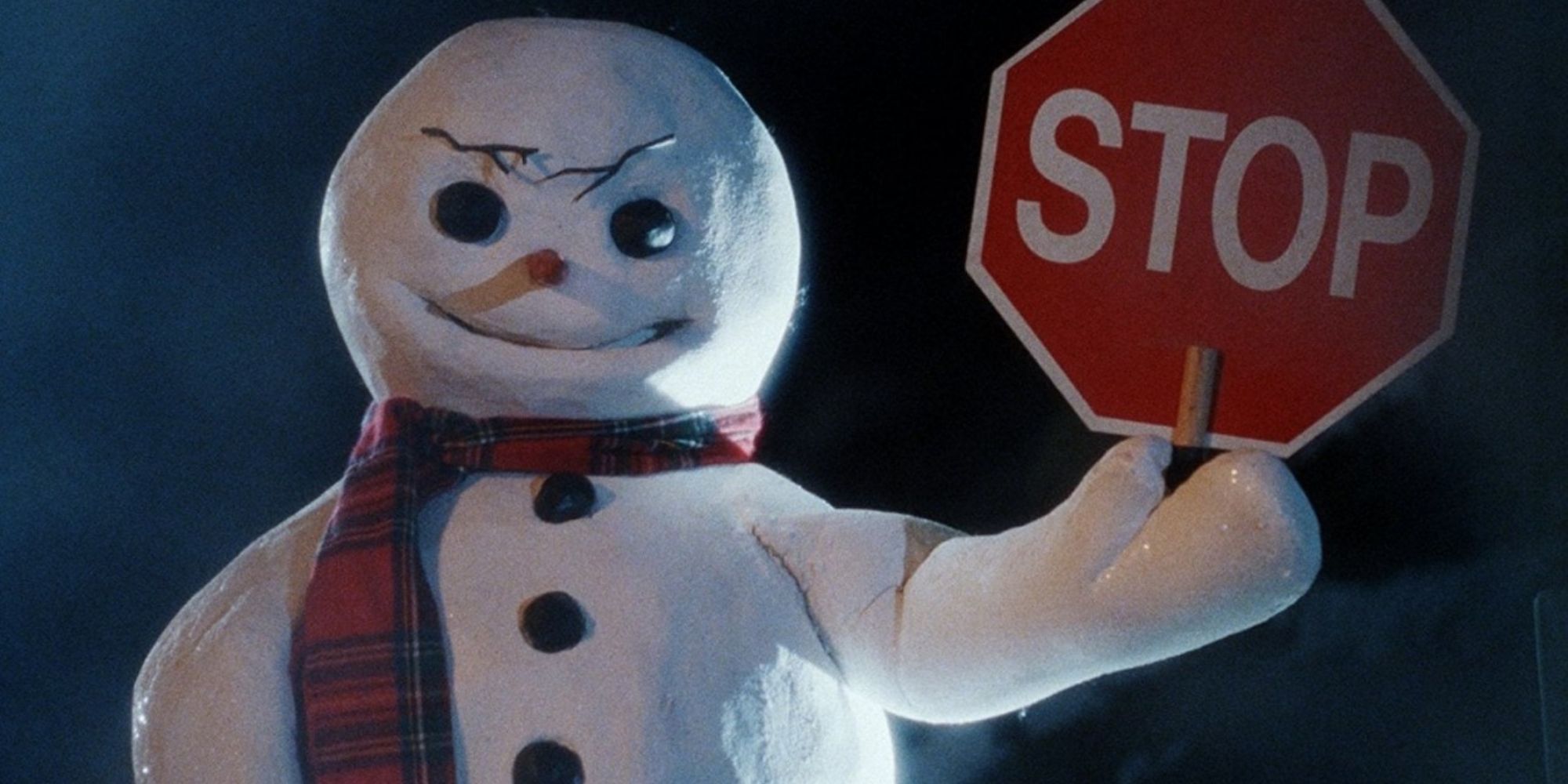 The killer snowman holds up a stop sign and grins evilly
