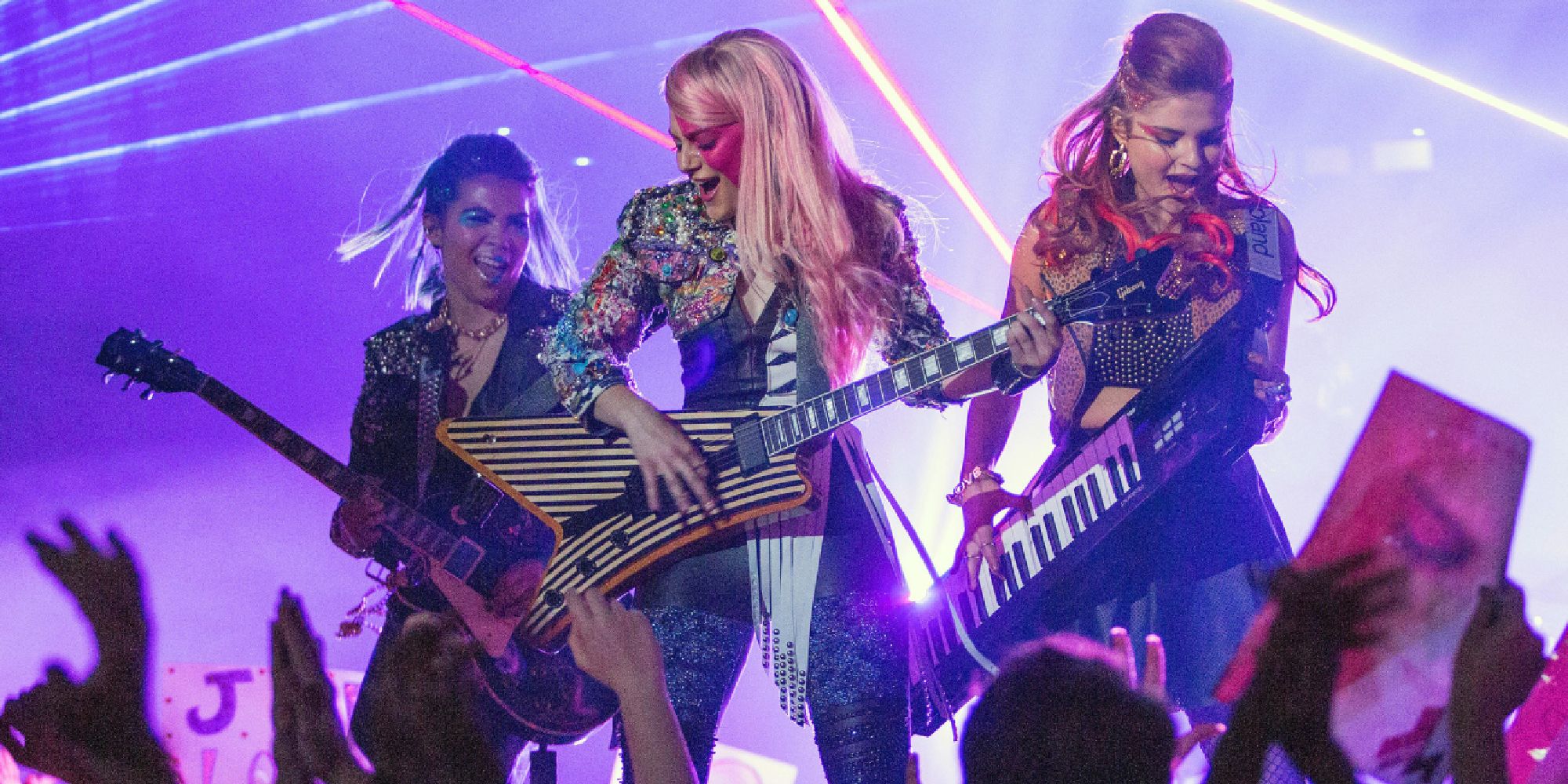 The band perform onstage with an enthusiastic crowd in Jem and the Holograms.