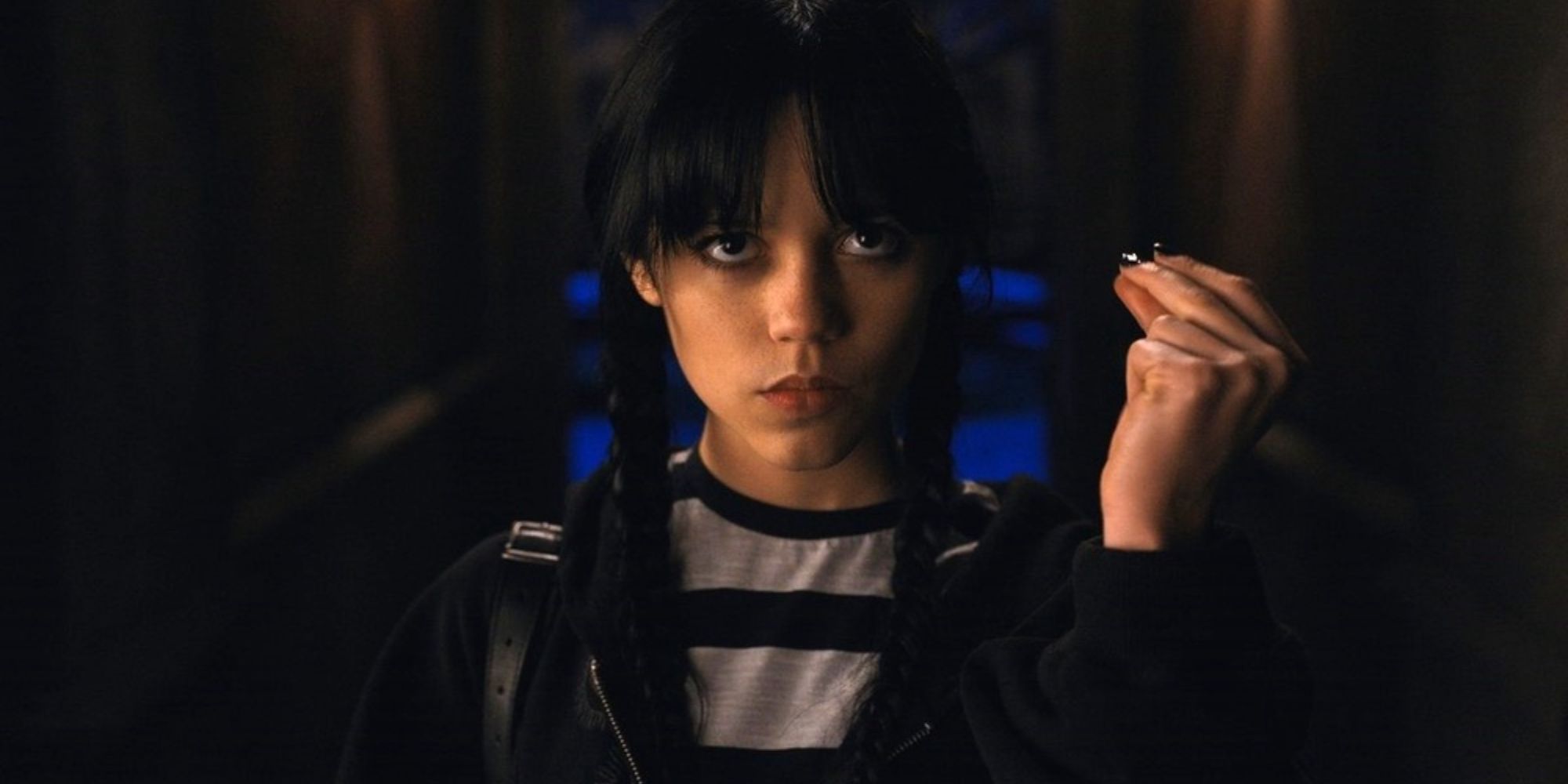 Wednesday Addams snapping her fingers in Wednesday.