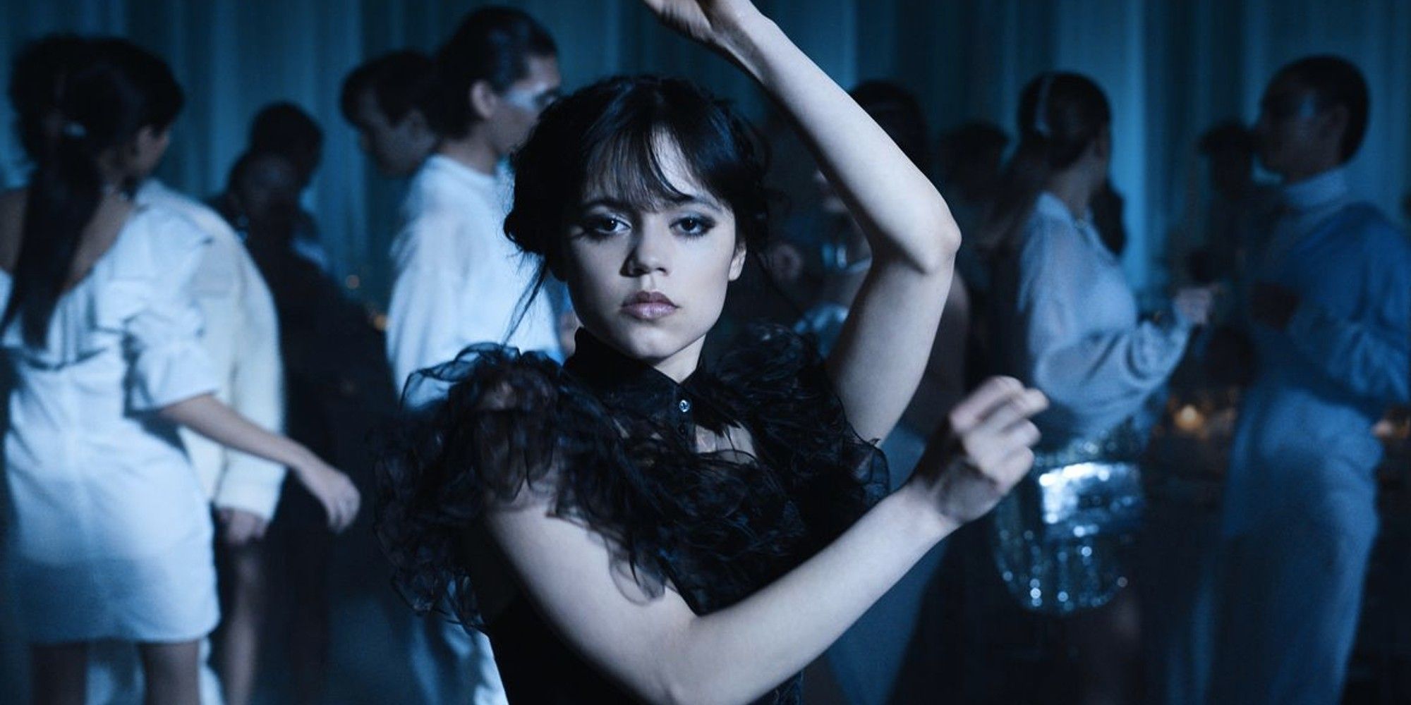 Jenna Ortega dancing with her arms up to Goo Goo Muck in Wednesday