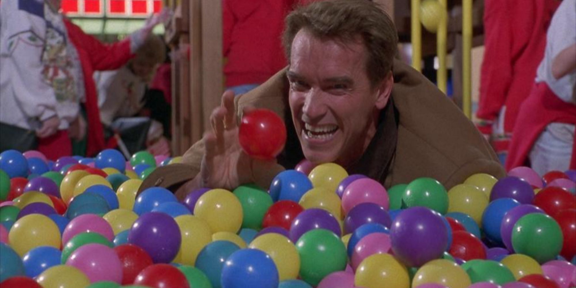 Arnold Schwarzenegger in a ball pit in Jingle All the Way