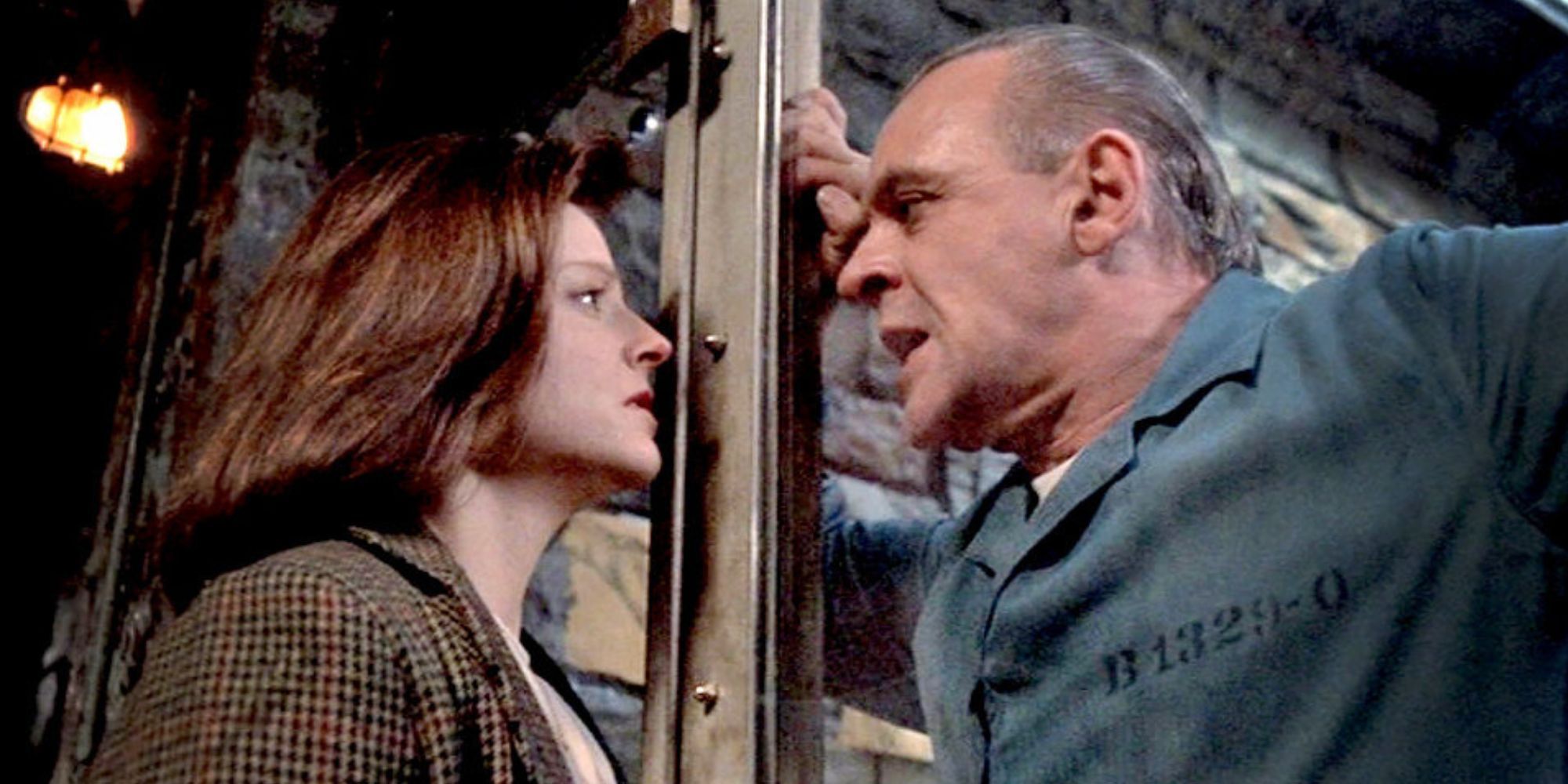 Jodie Foster looking at Anthony Hopkins behind the glass of his cell in Silence of the Lambs