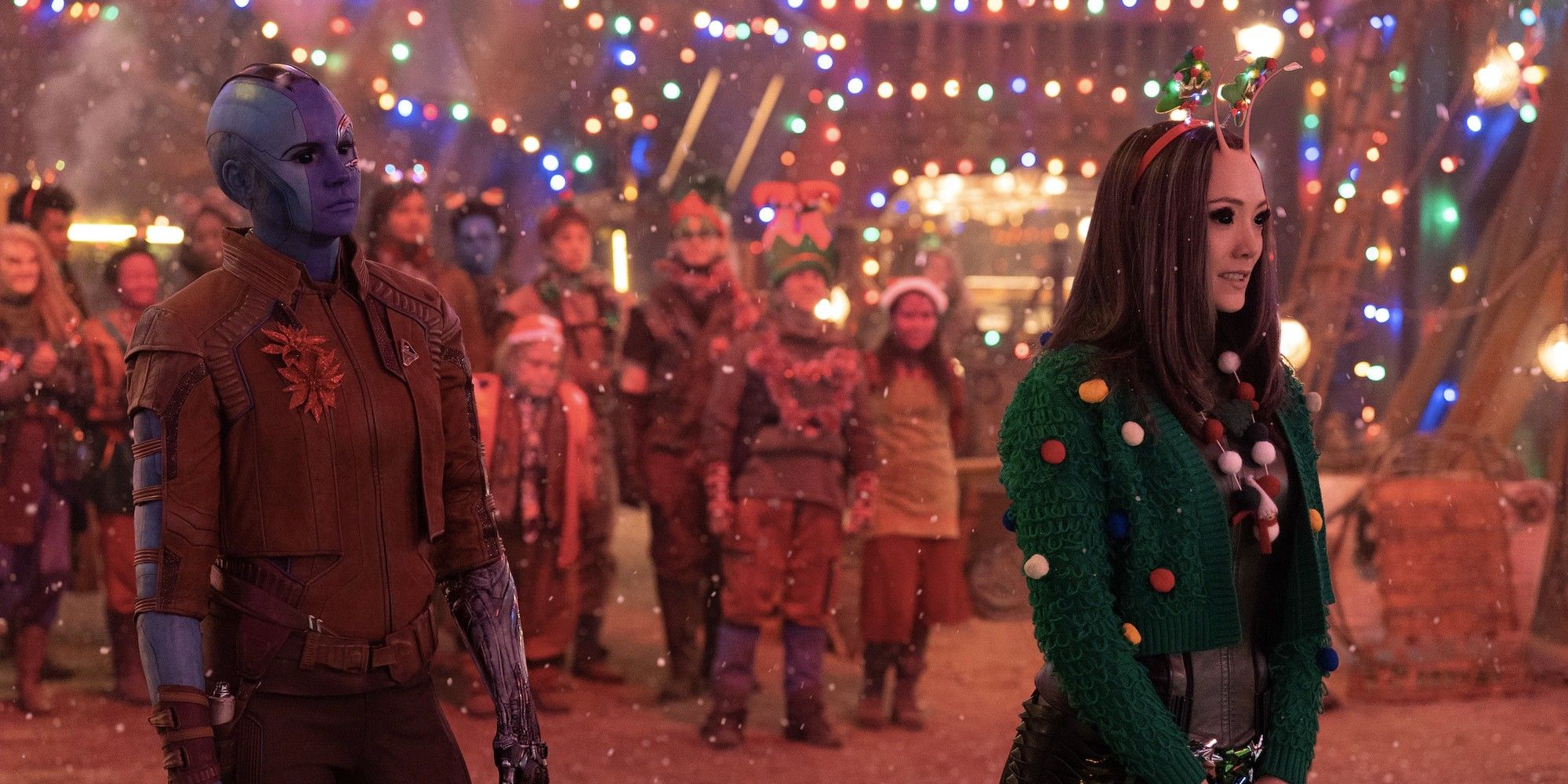 Karen Gillan as Nebula looking at a smiling Pom Klementieff as Mantis in 'The Guardians of the Galaxy Holiday Special'