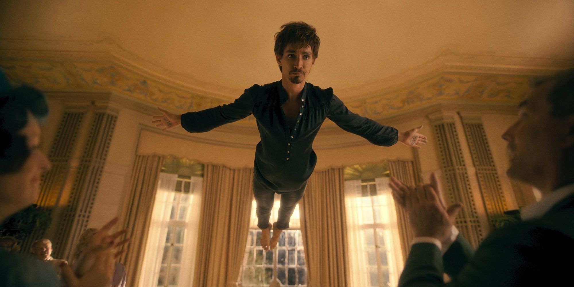 Klaus Hargreeves floating above everyone in 'The Umbrella Academy.'