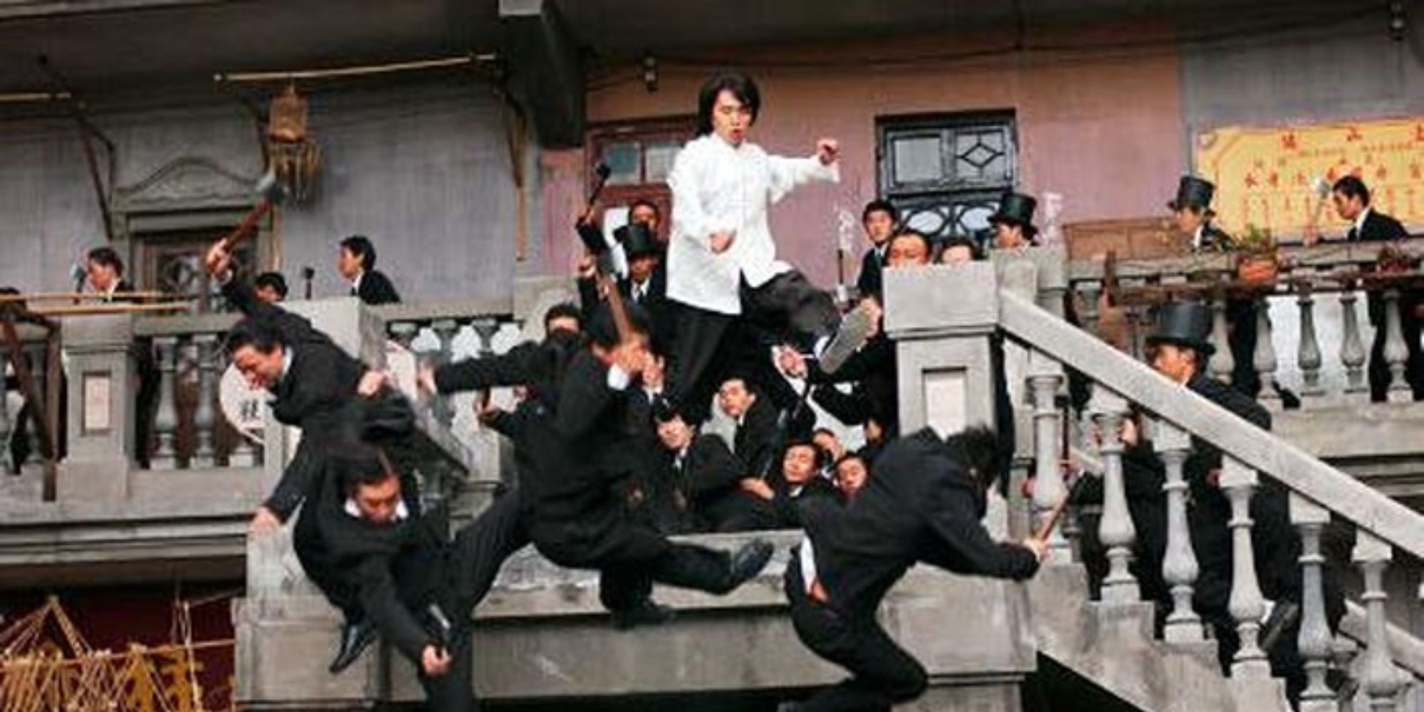 A man kicks a bunch of villains off a balcony.