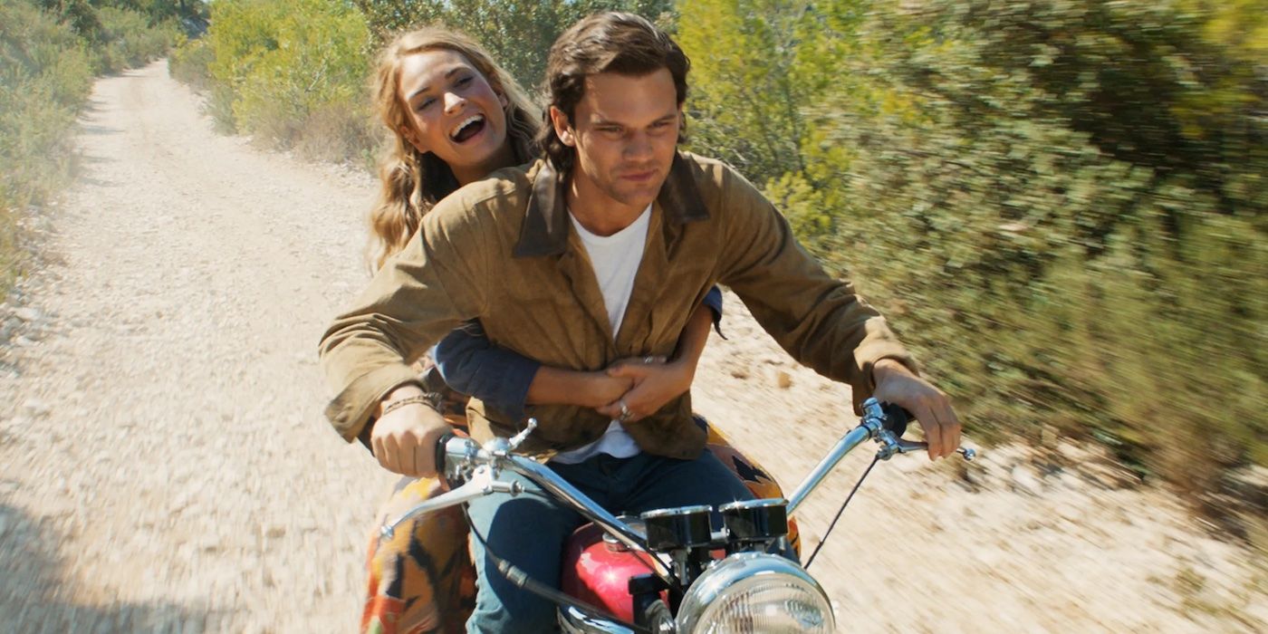 Lily James and Jeremy Irvine as young Donna and Sam, riding a motorcycle in Mamma Mia Here We Go Again