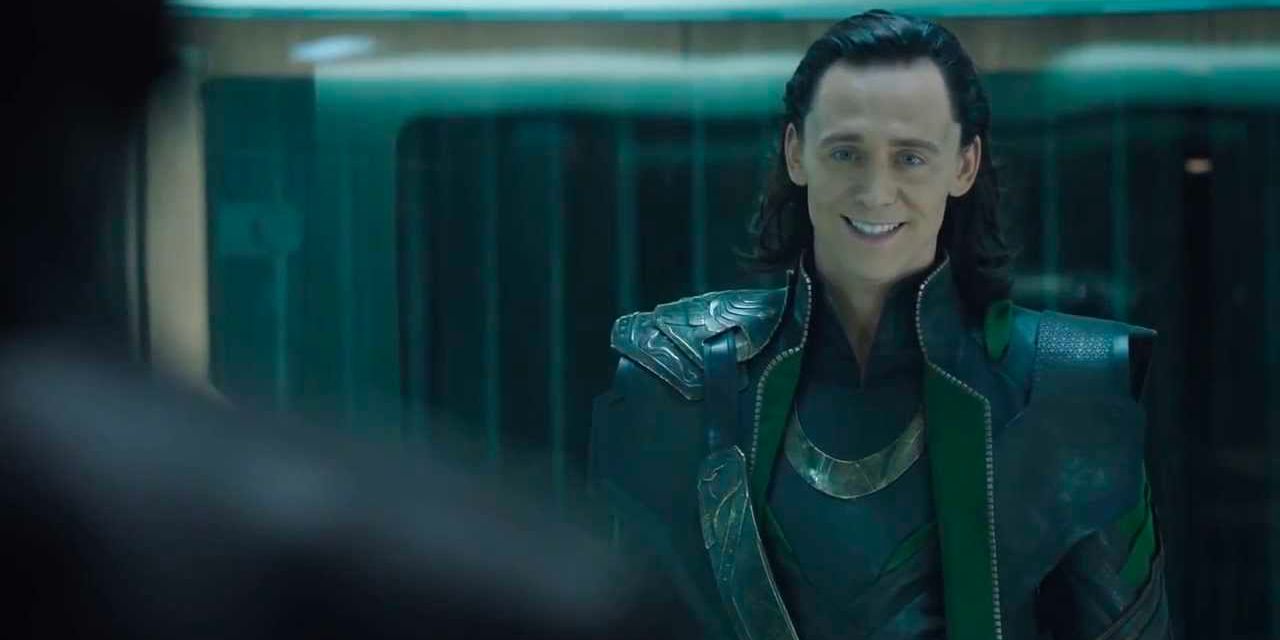 Loki smiles mischievously while being held in captivity by the Avengers.