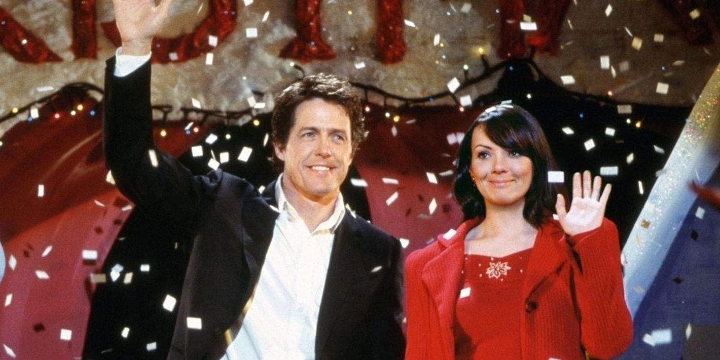 Hugh Grant and Martine McCuthenson standing on a stage together in Love, Actually