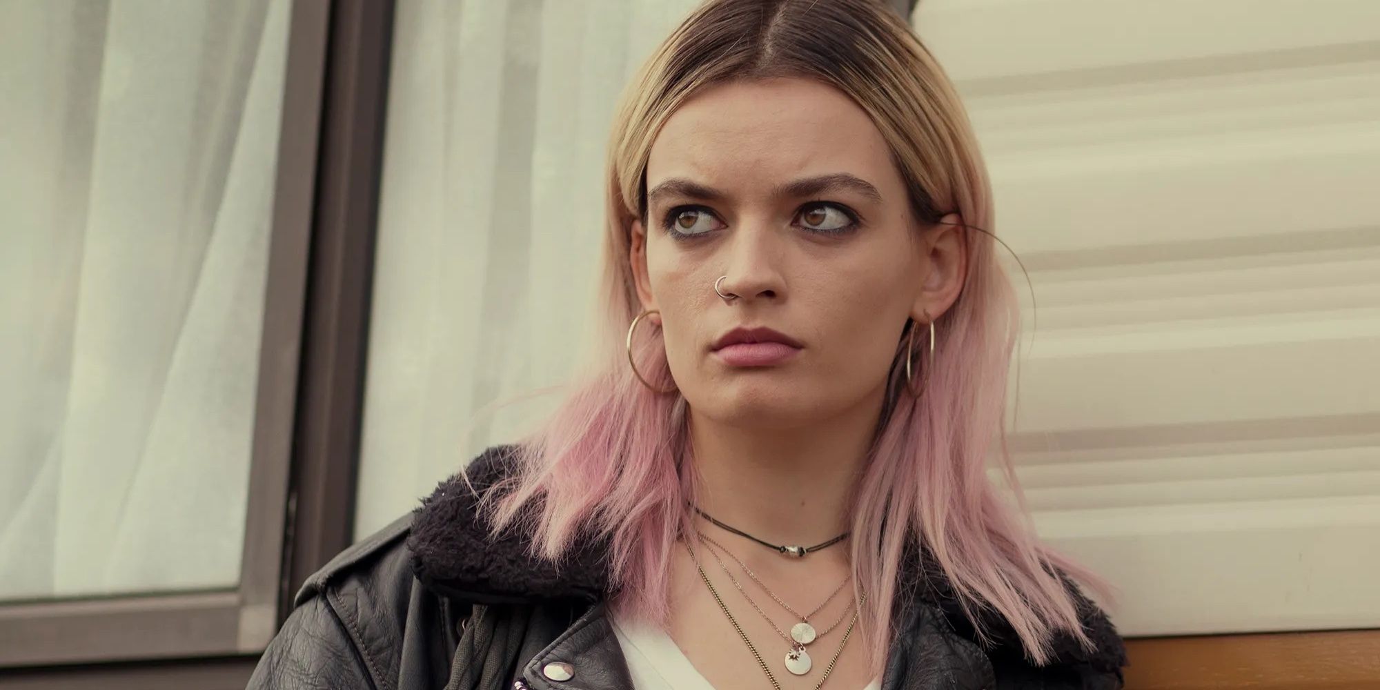 Maeve Wiley with her pink hair, piercings, and leather jacket in 'Sex Education.'