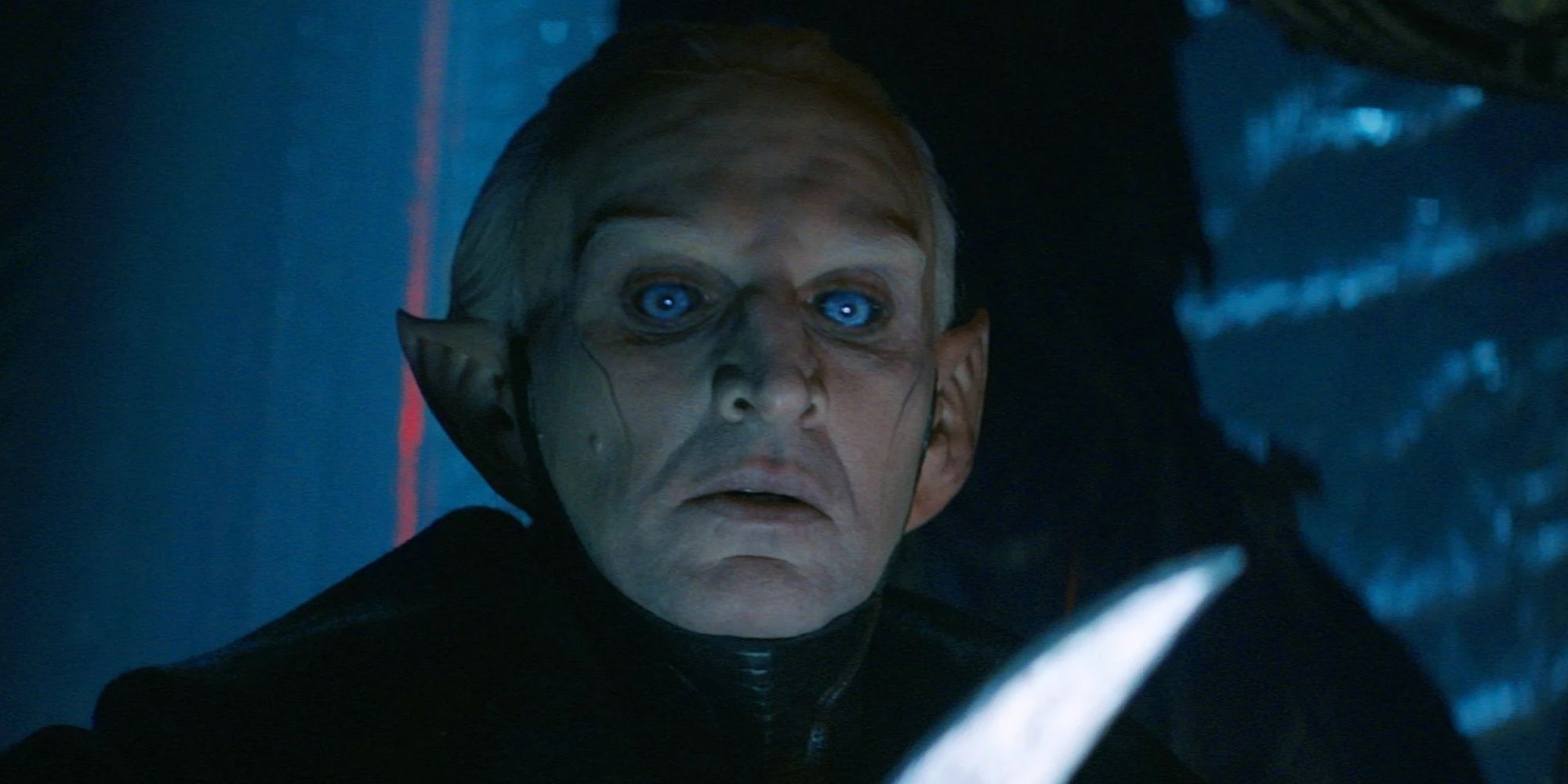 Malekith holding a blade and looking intently in Thor: The Dark World