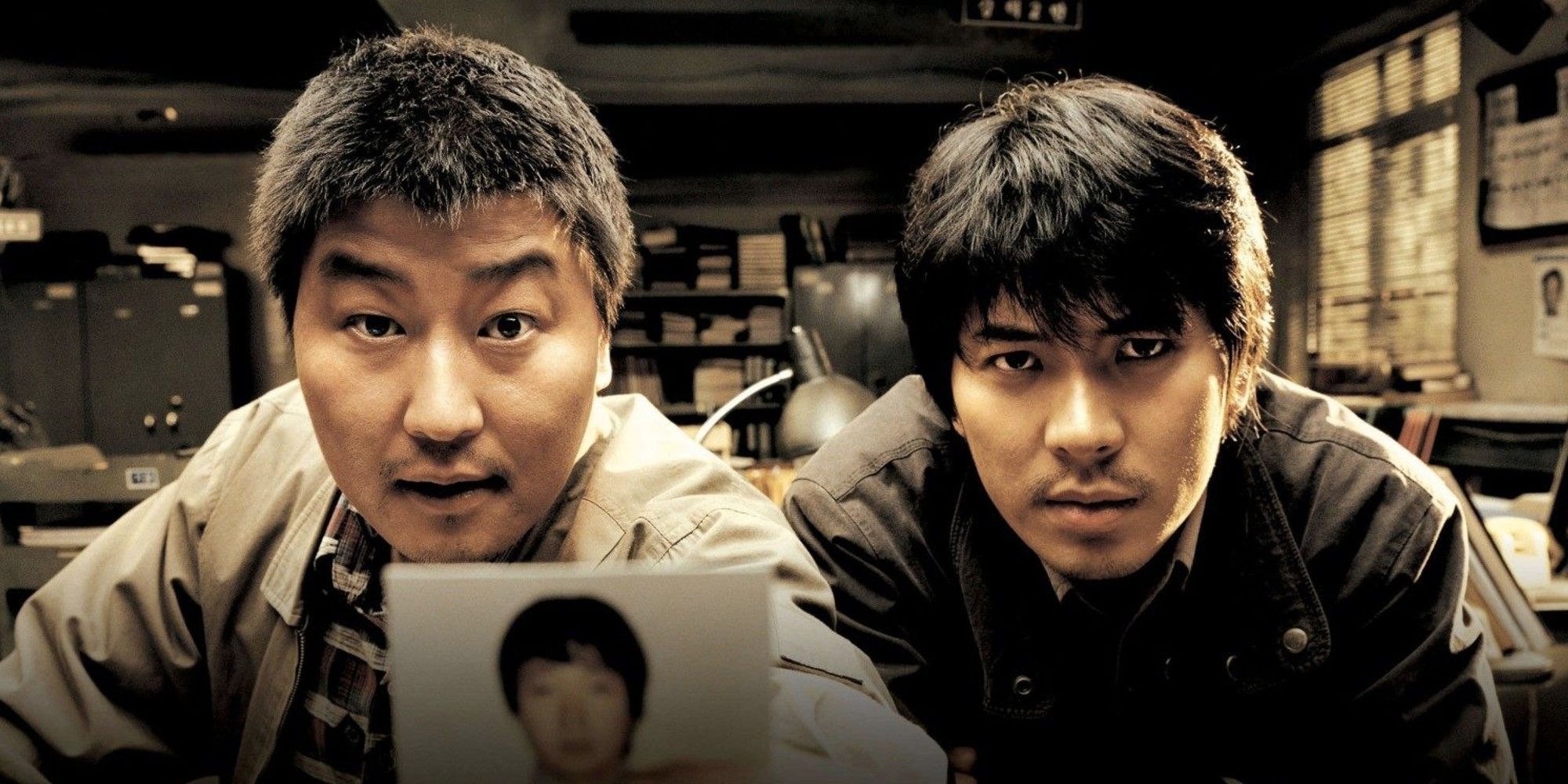 Song Kang-ho and Kim Sang Kyung looking at the camera in Memories of Murder