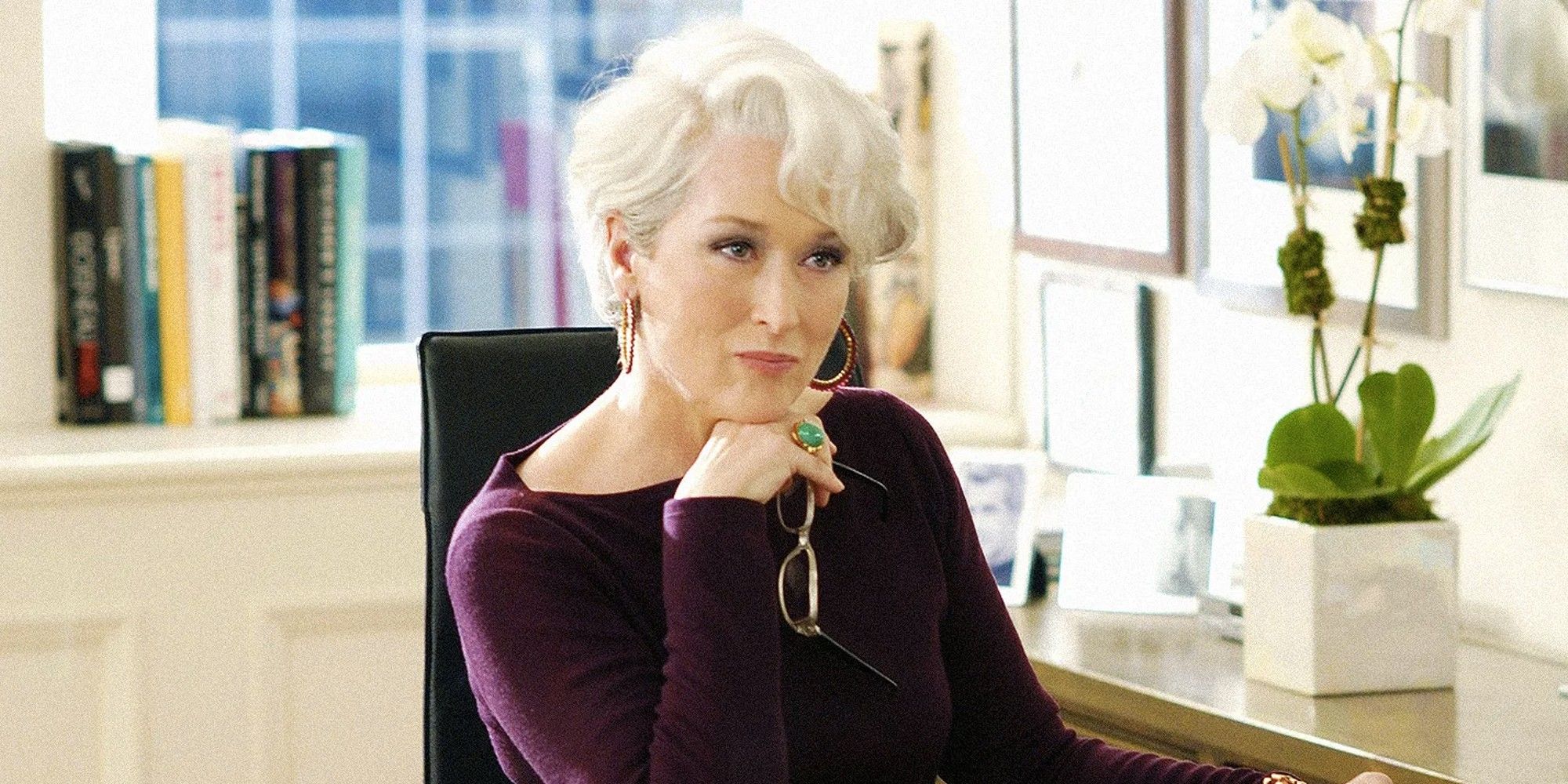 Miranda looking intently at something off-camera while at her office in The Devil Wears Prada.