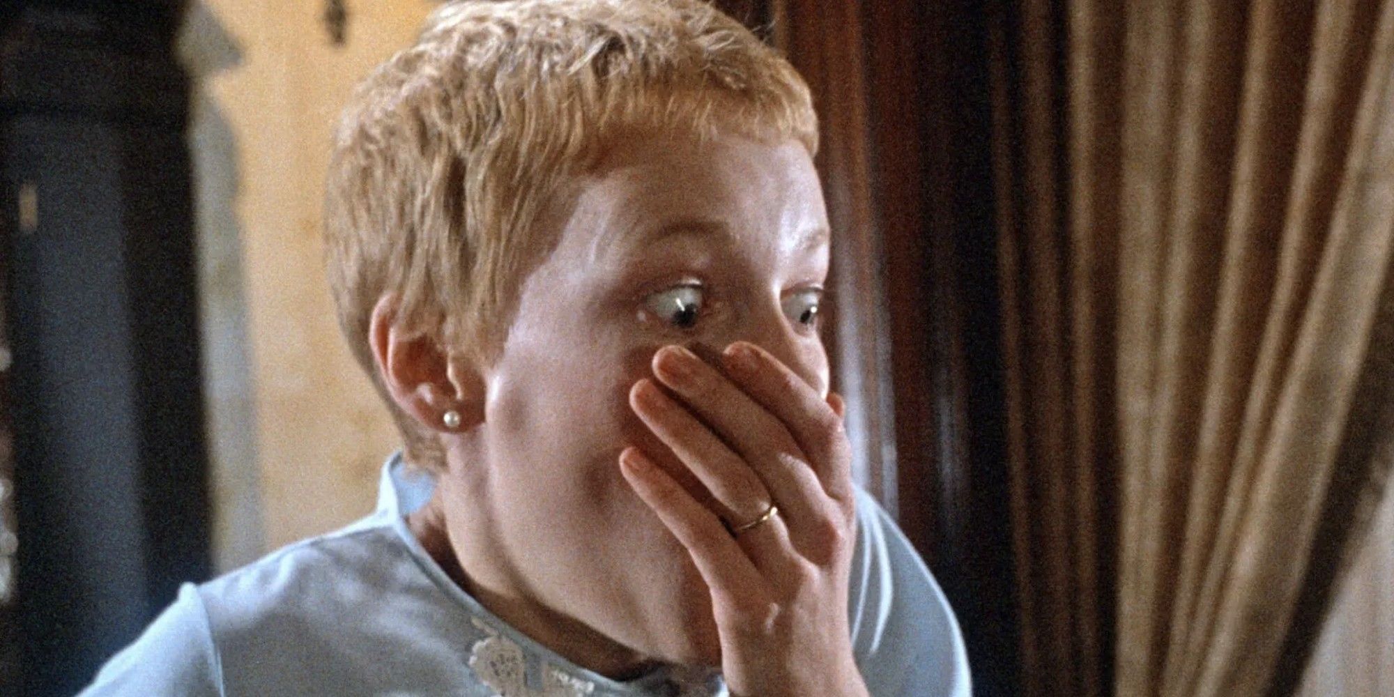 Mia Farrow covering her mouth with her hand in 'Rosemary's Baby'