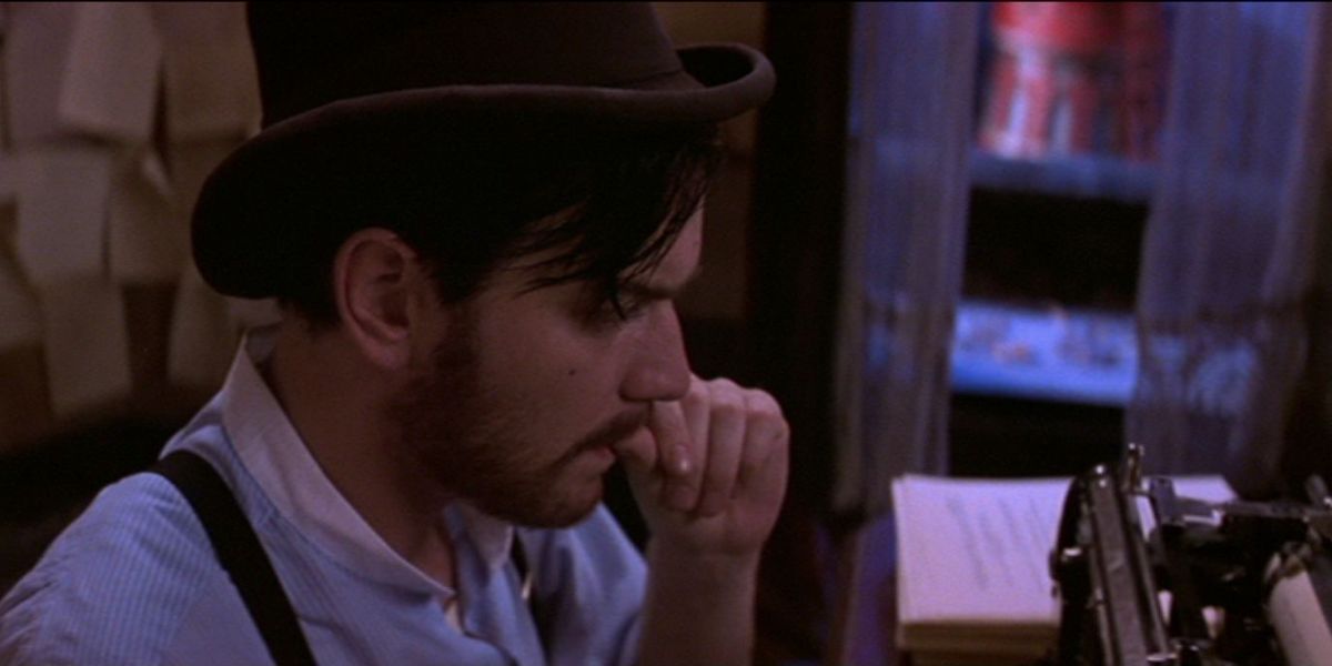 Ewan McGregor as Christian sitting at a typewriter at the Moulin Rouge!