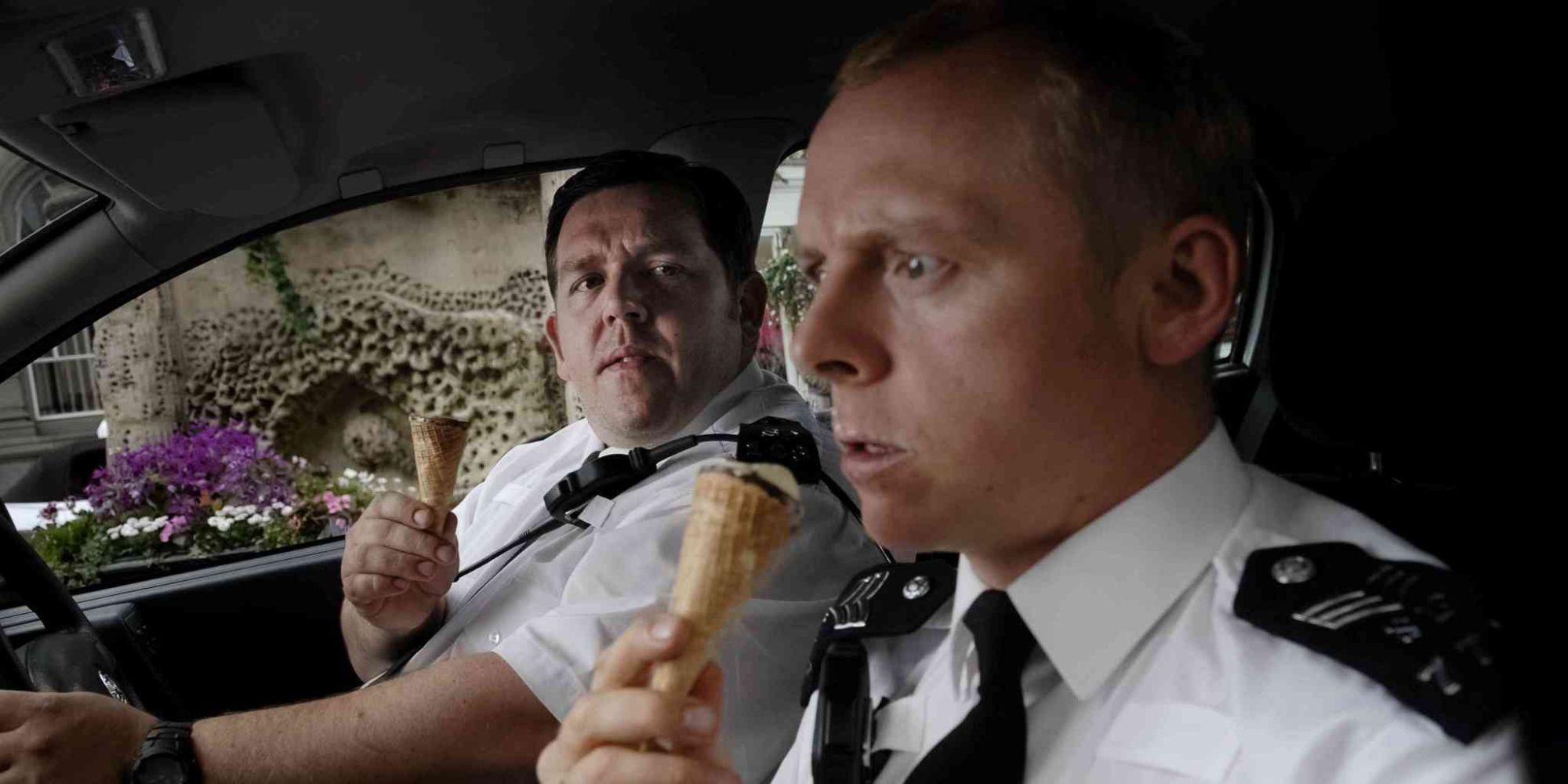 Nick Frost and Simon Pegg as two police officers sitting in their car eating ice cream in Hot Fuzz