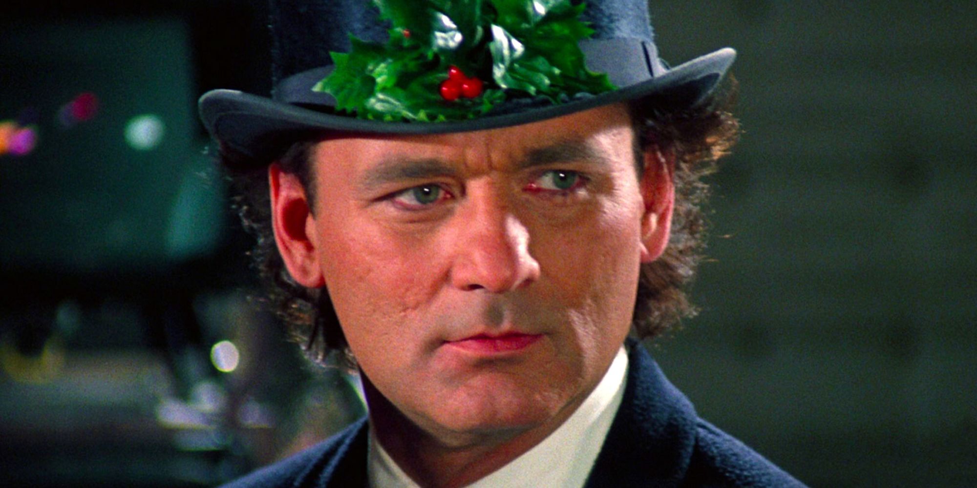 Frank Cross wears a top hat with a holly on it 