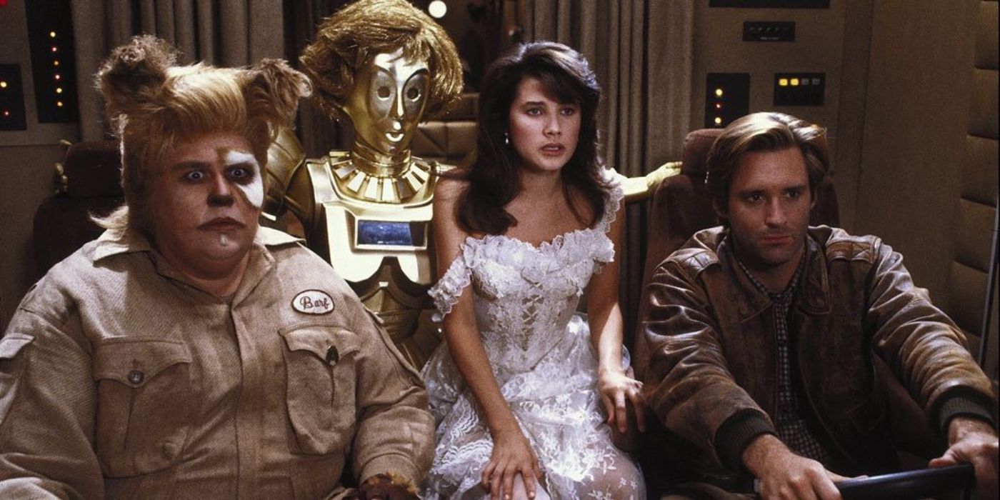 Barf (John Candy), Dot Matrix (Lorene Yarnell Jansson), Princess Vespa (Daphne Zuniga), and Lone Starr (Bill Pullman) looking concerned in Spaceballs