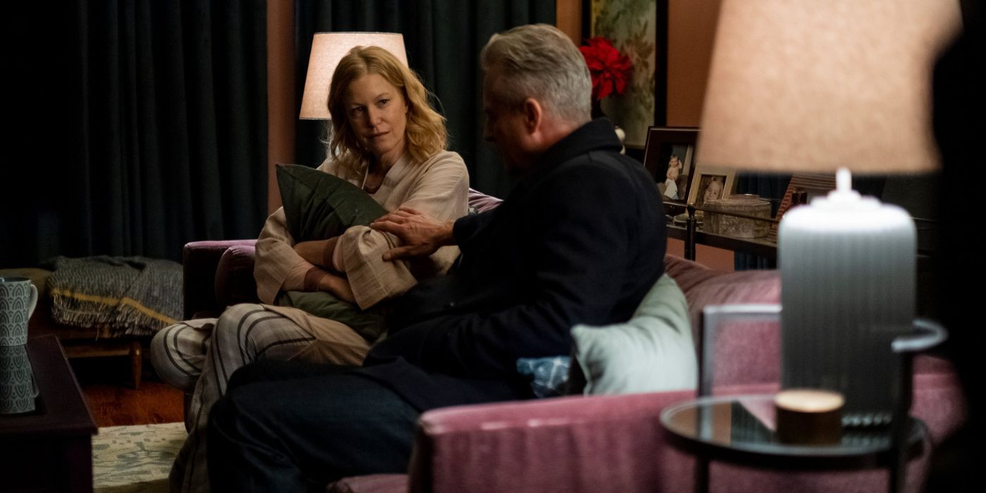 Anna Gunn sitting on a couch holding a pillow in The Apology 