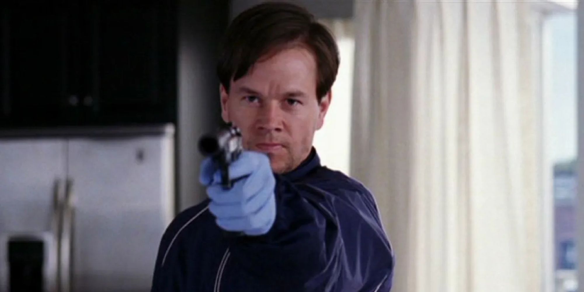Mark Wahlberg pointing a gun in The Departed