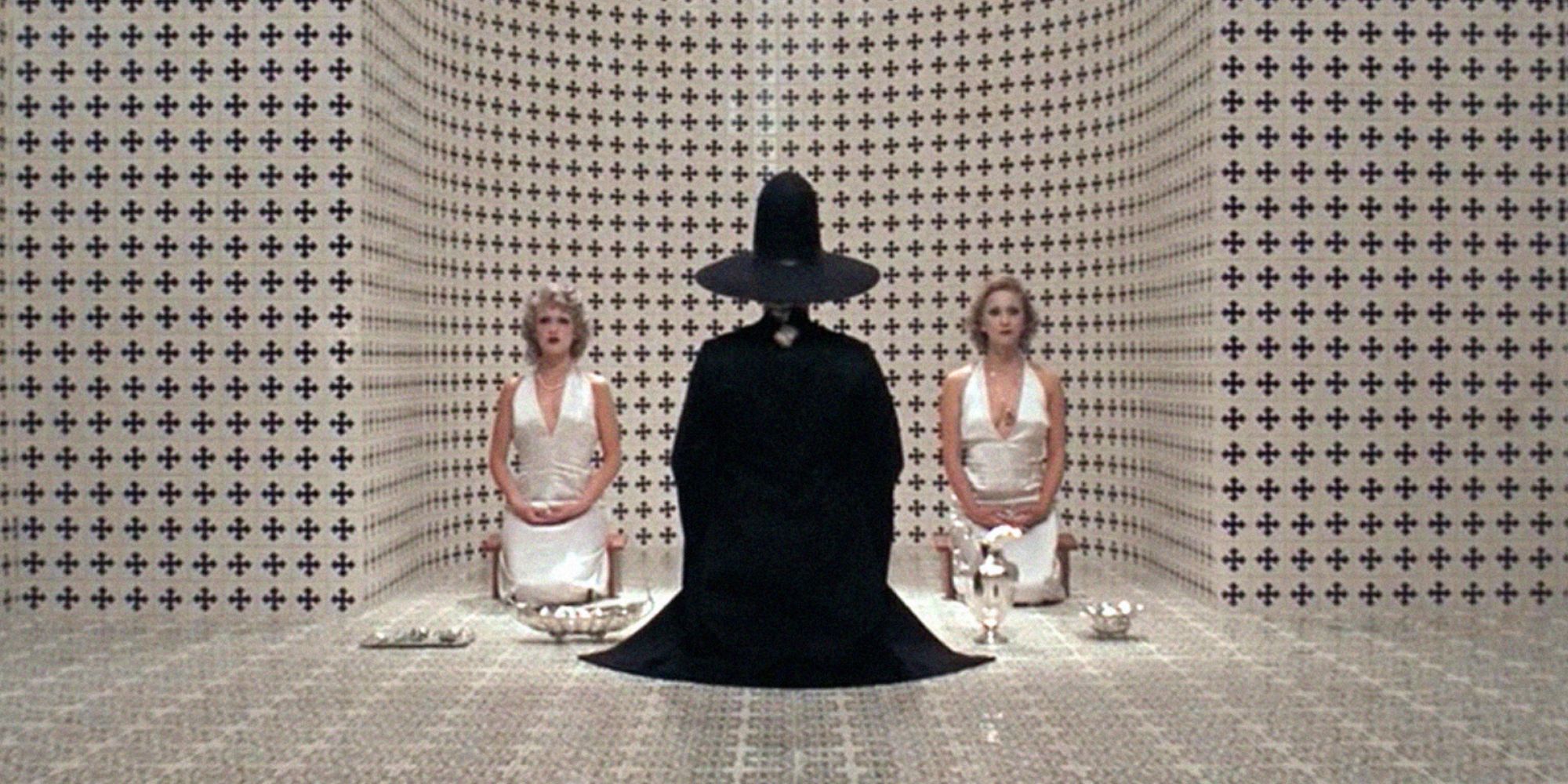 Three figures kneeling on a floor in The Holy Mountain - 1973