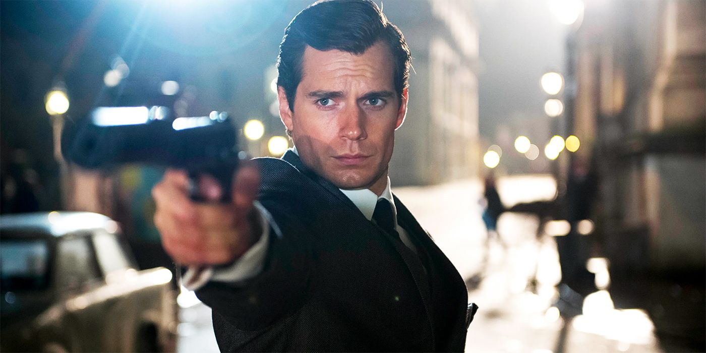 Napoleon Solo (Henry Cavill) aiming a gun at an object off-camera in 