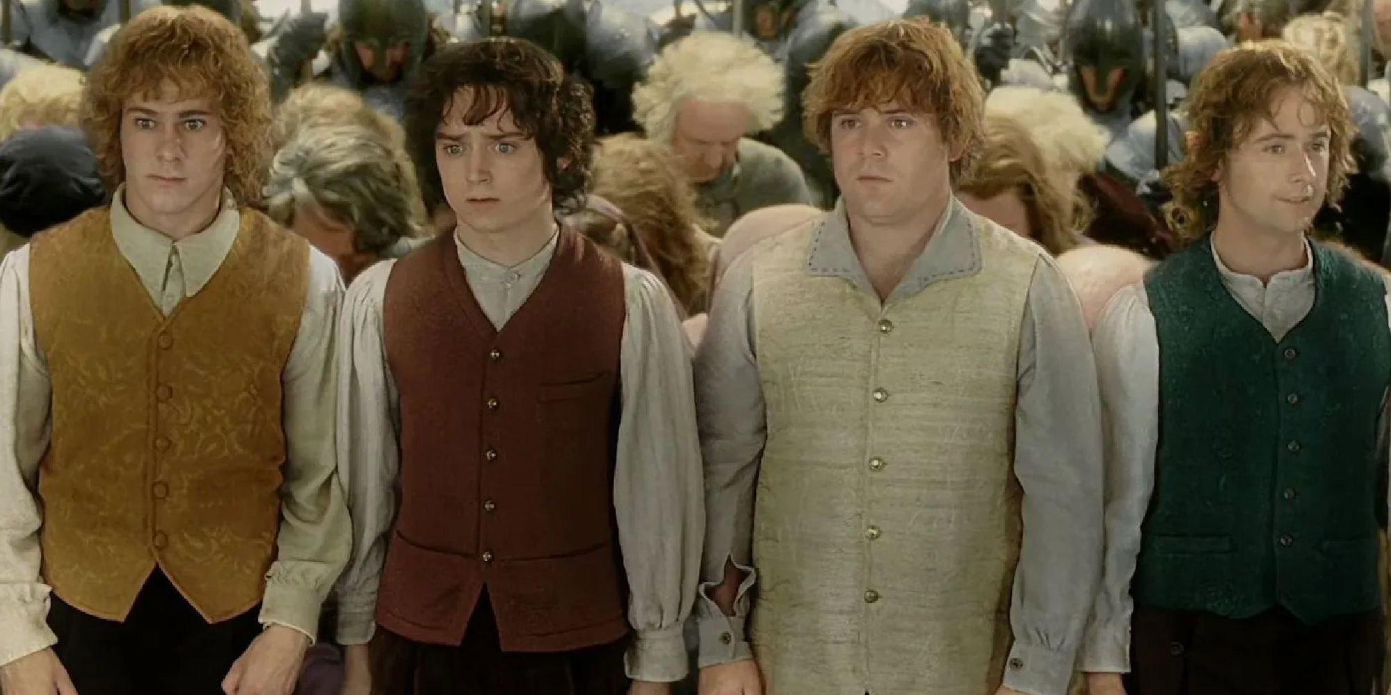 Merry, Frodo, Sam, and Pippin standing together and looking shocked in The Lord of the Rings: The Return of the King