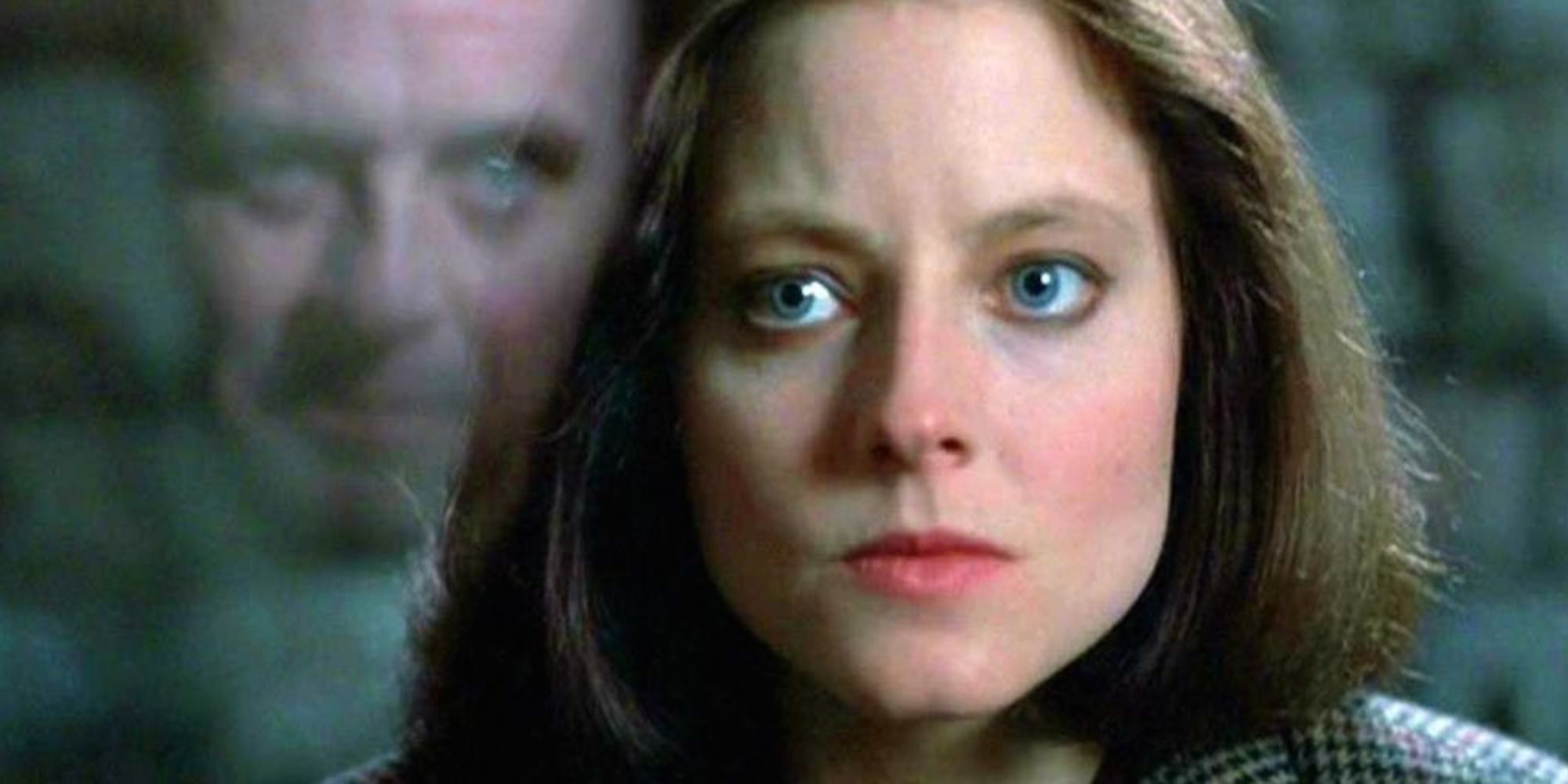 Clarice Starling, looking at Hannibal Lecter, who is reflected in the glass in The Silence of the Lambs (1991)