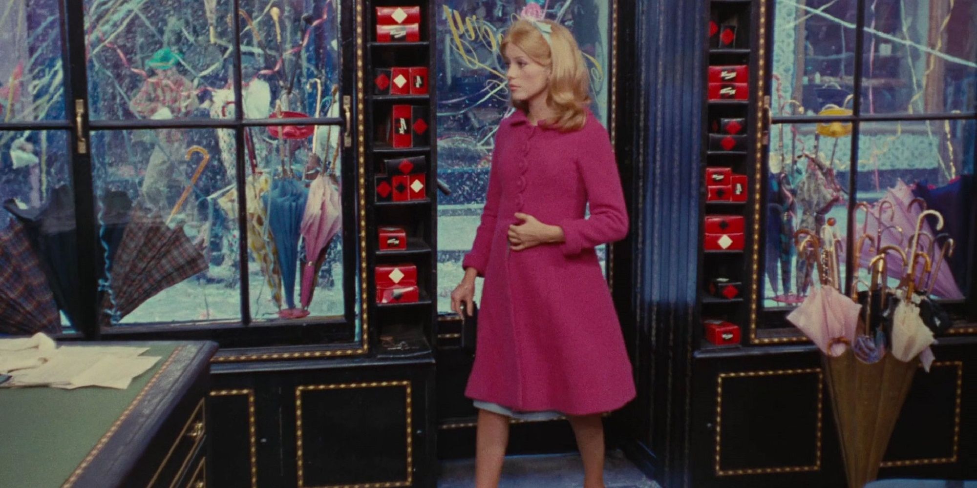 Geneviève in front of her umbrella boutique in The Umbrellas of Cherbourg.