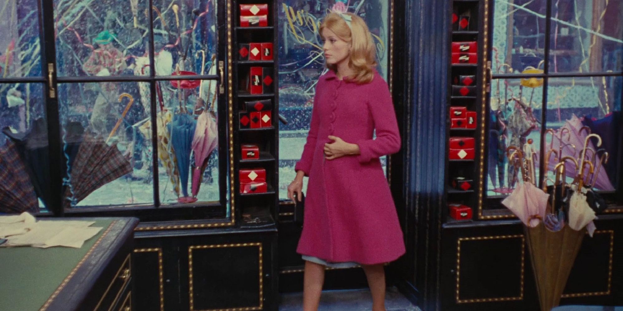 Genevieve in front of her umbrella boutique in 'The Umbrellas of Cherbourg.'