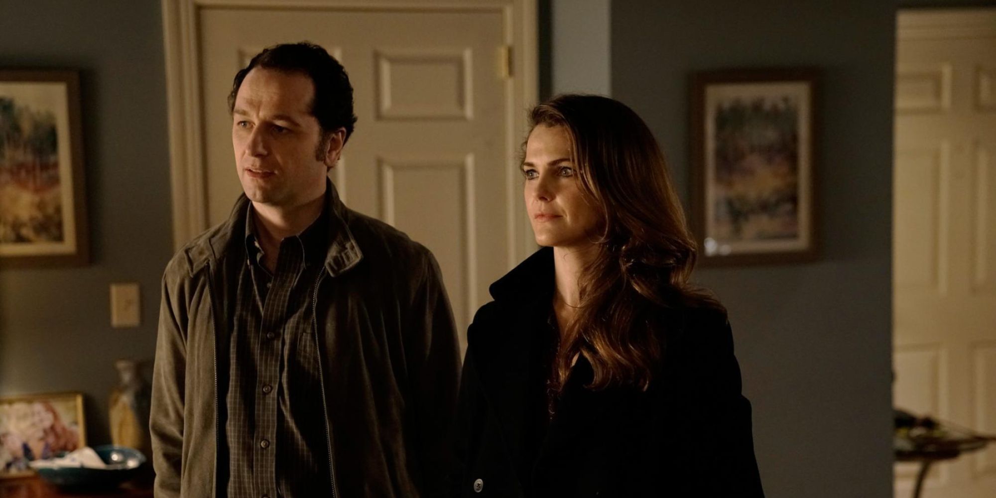 Phillip (Matthew Rhys) and Elizabeth (Keri Russell) Jennings standing side by side and looking in the same direction in 'The Americans'.