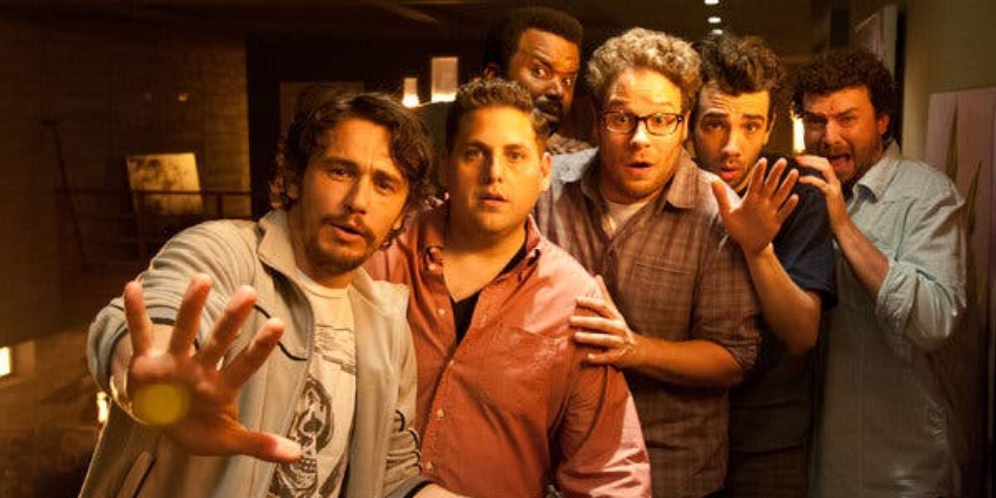 James Franco, Jonah Hill, Seth Rogen, Craig Robinson, Jay Baruchel, and Danny McBride huddled together in This Is the End.