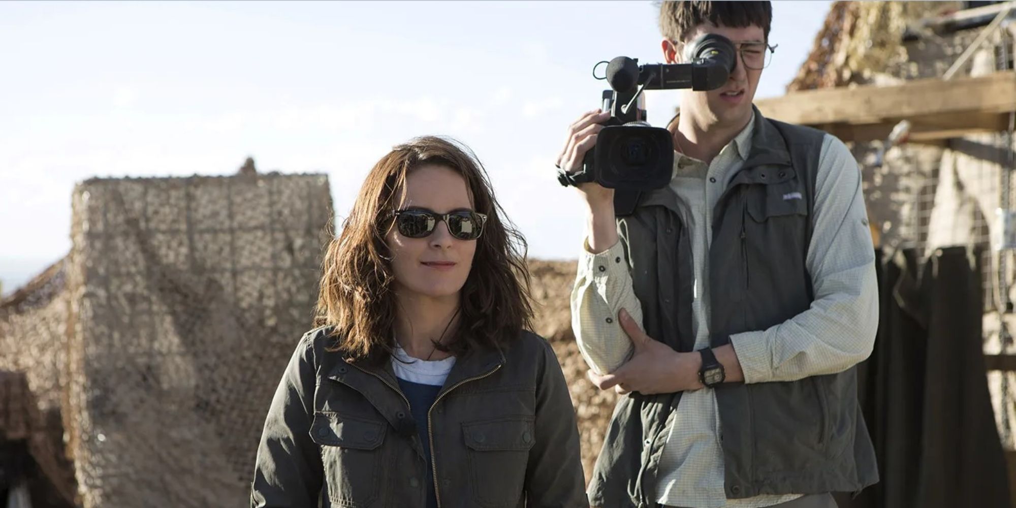 Tina Fey in the desert with a cameran behind her in 'Whiskey Tango Foxtrot'