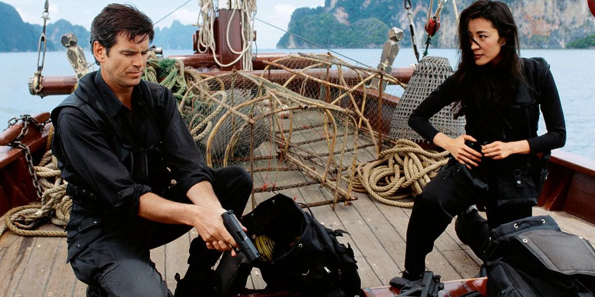 Pierce Brosnan as James Bond and Michelle Yeoh as Mai Lin on a boat in Tomorrow Never Dies.