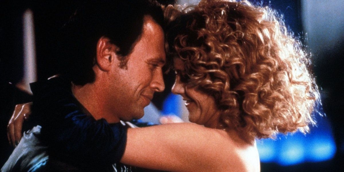 Meg Ryan as Sally cuddling Billy Crystal as Harry on New Year's in When Harry Met Sally...