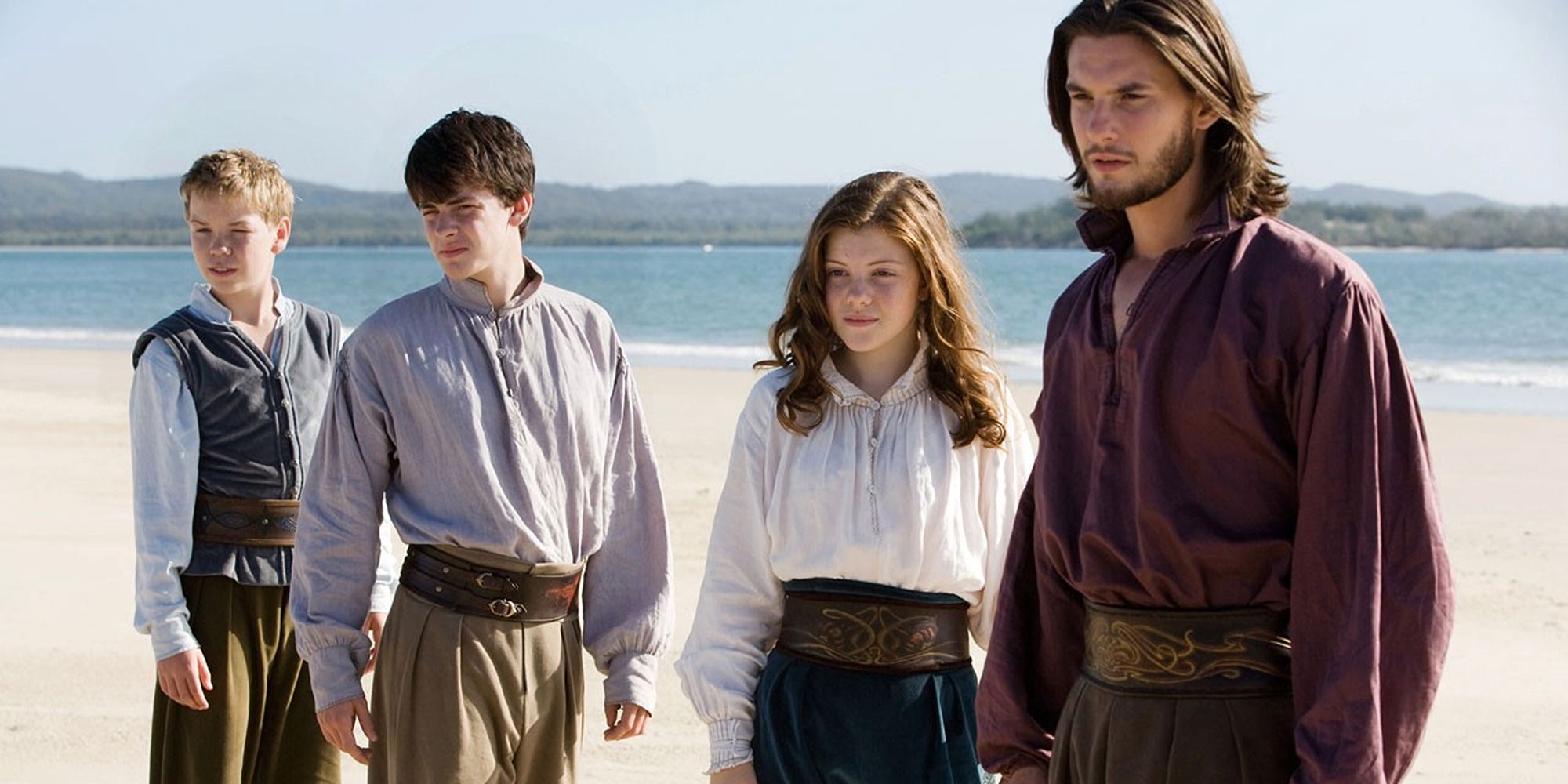 three teenage boys and a teenage girl by the beach